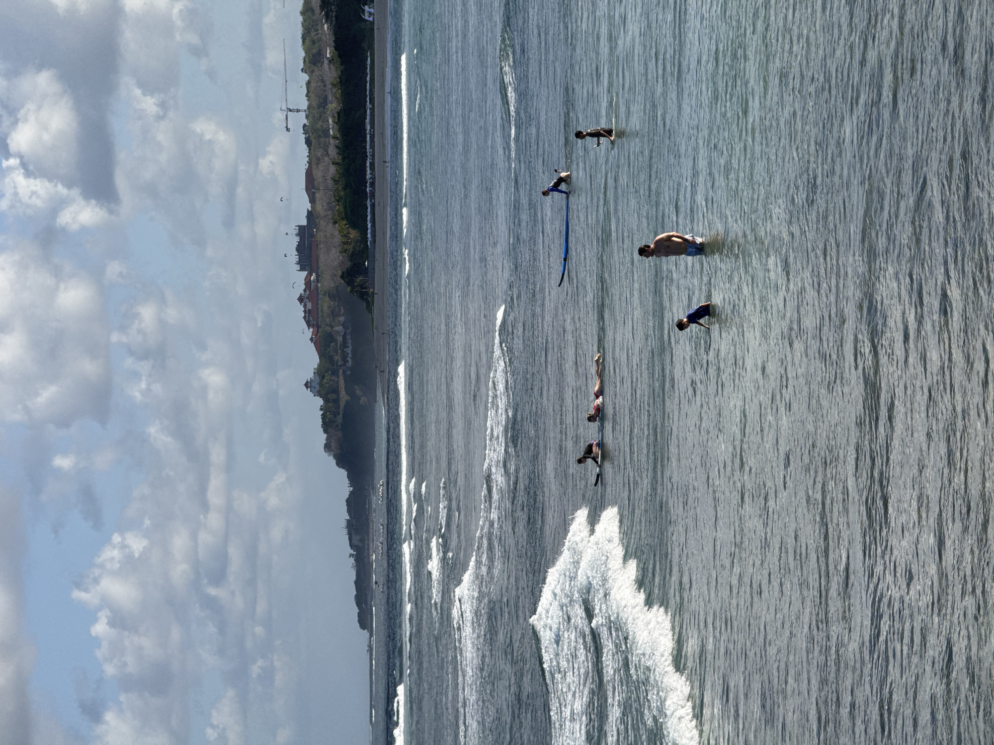 Surf and bougainvillea on a cloudy morning in Kuta Selatan