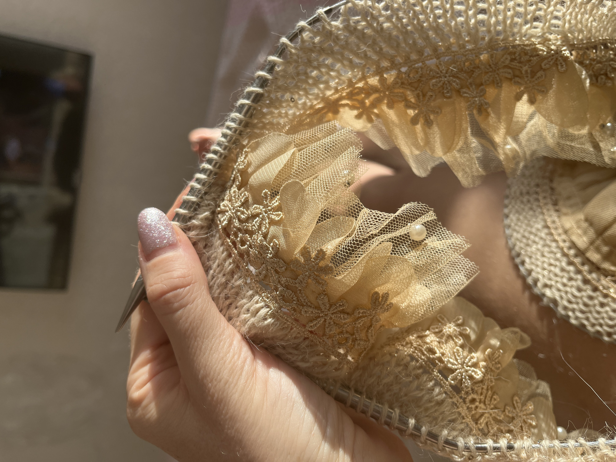 Person knits decorative beige fabric in Nizhny Novgorod