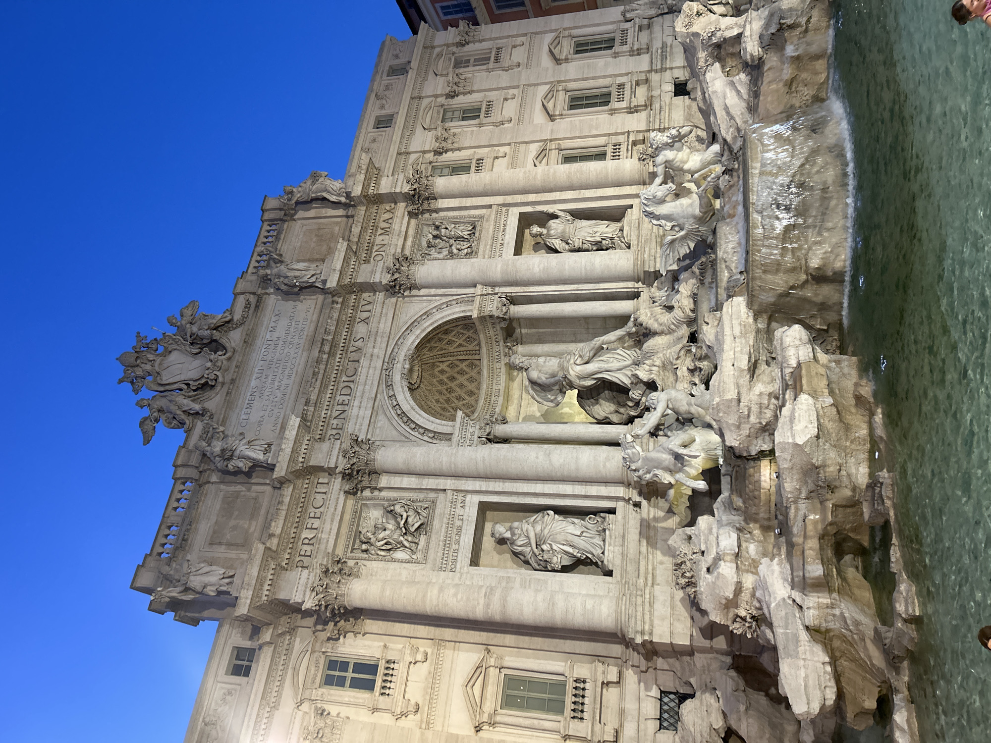 Trevi Fountain glowing under artificial lights at night
