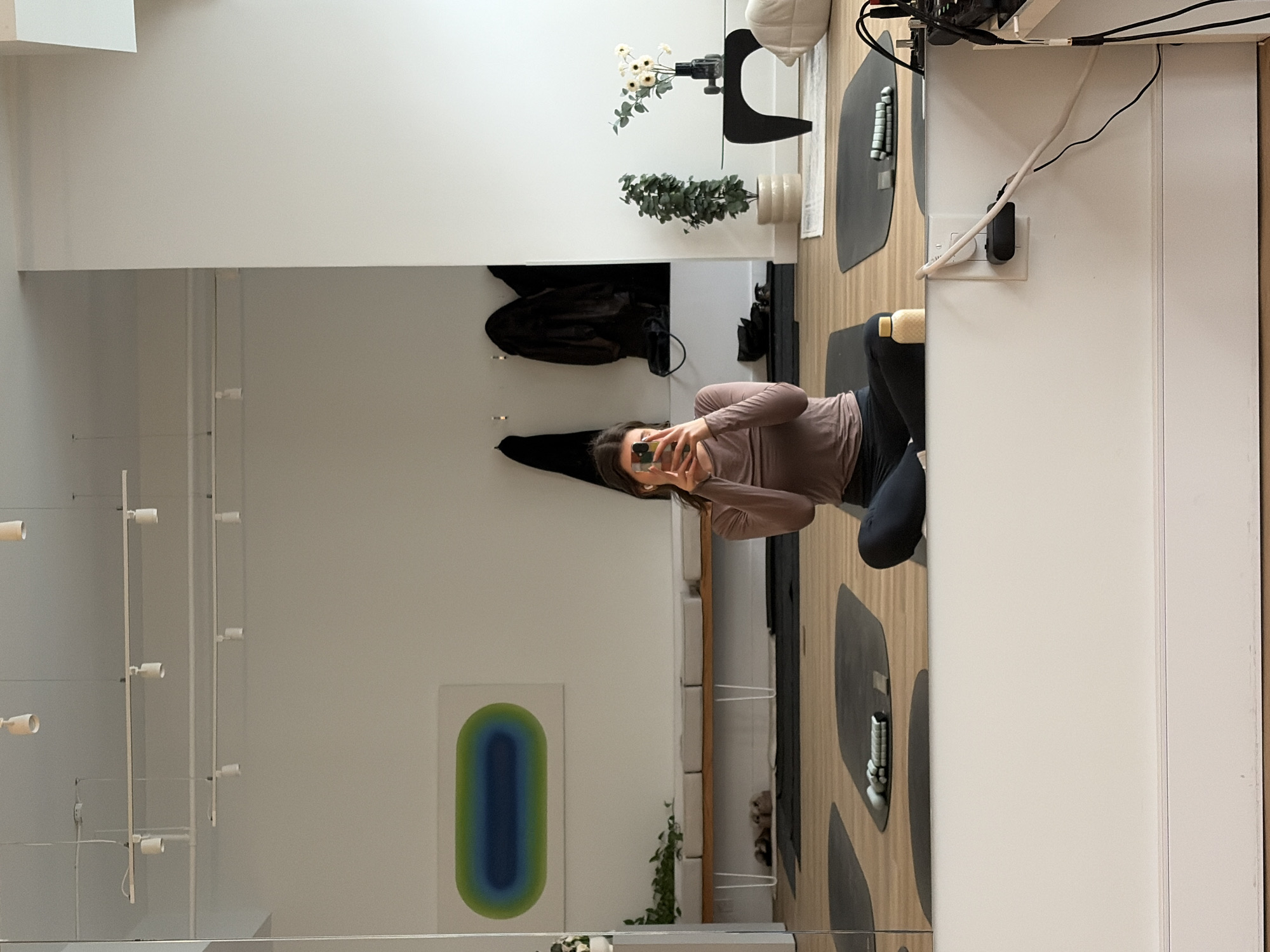Woman takes mirror selfie in modern Montreal apartment
