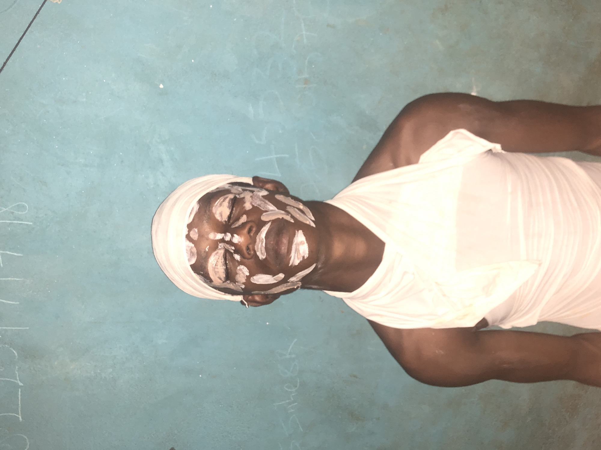 Traditional ceremony participants observed in white paint, Idima Nigeria
