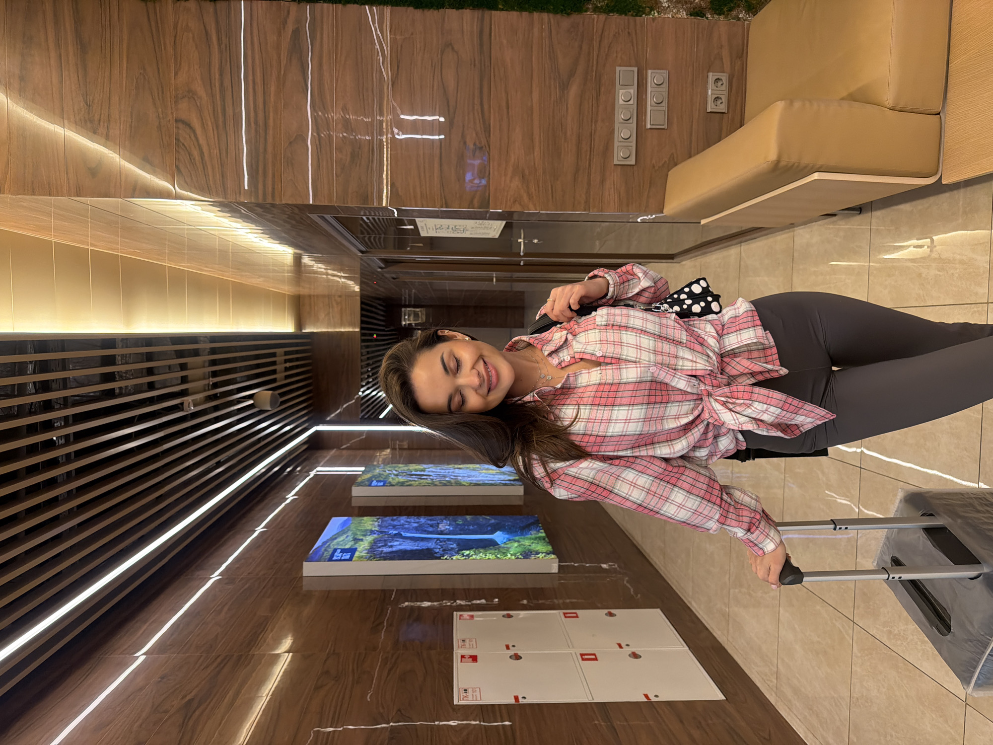 Woman travels with luggage, group photographed at Russian airport