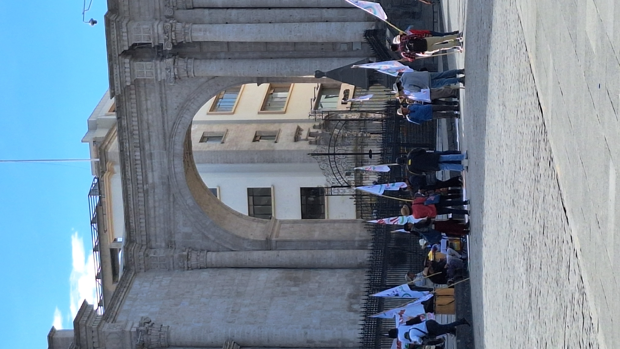 People gather at stone archway in Arequipa, Peru