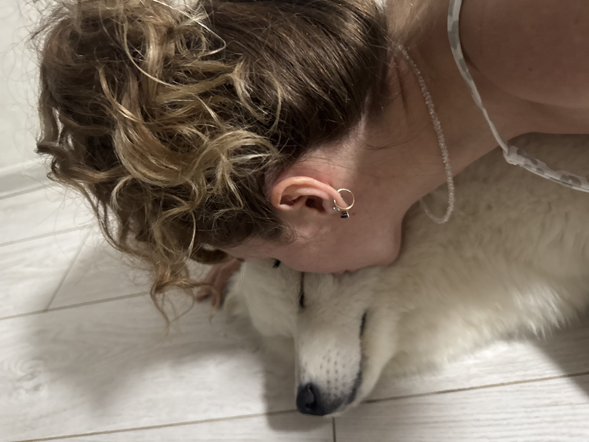 Woman and white Samoyed dog captured in intimate moments