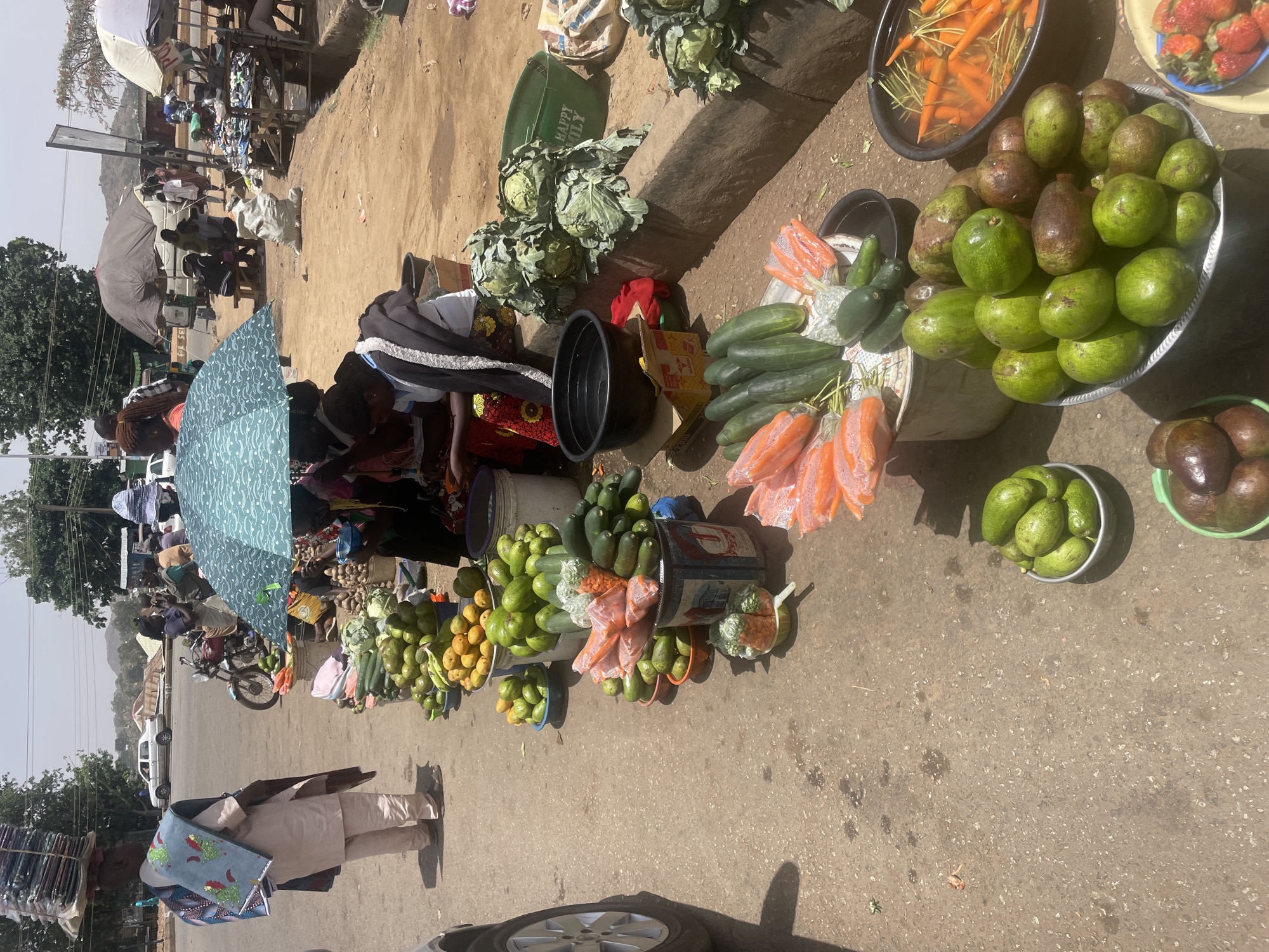 Street vendors sell fresh produce in Nigerian marketplace