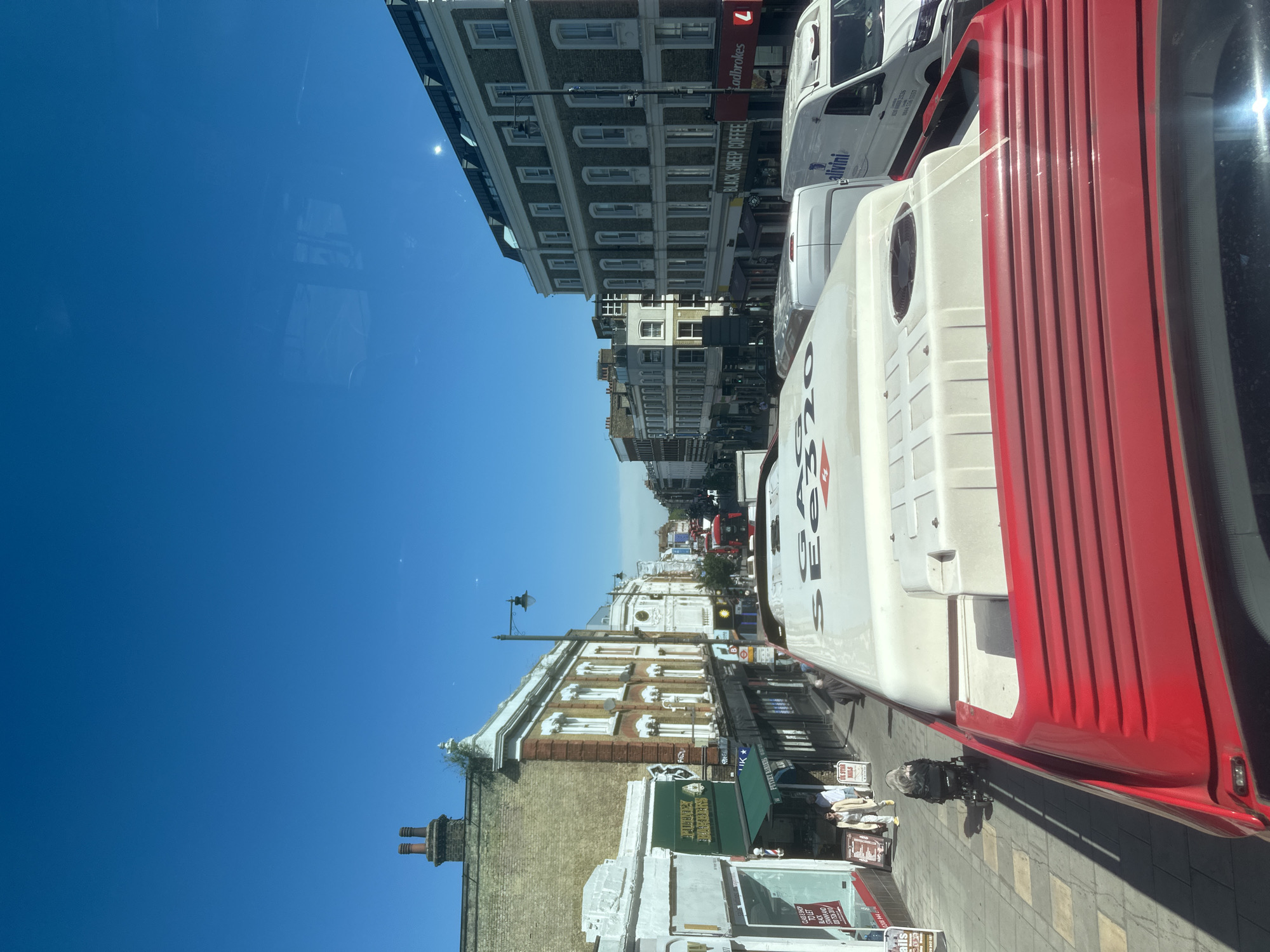 Sunny London street scene captured from elevated bus perspective