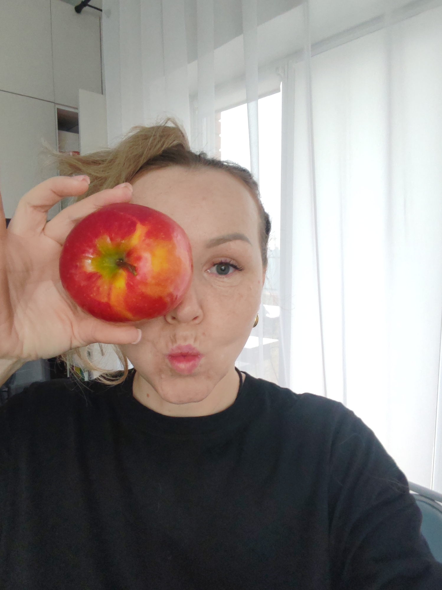 Woman takes selfies with apple in Chaikovsky home