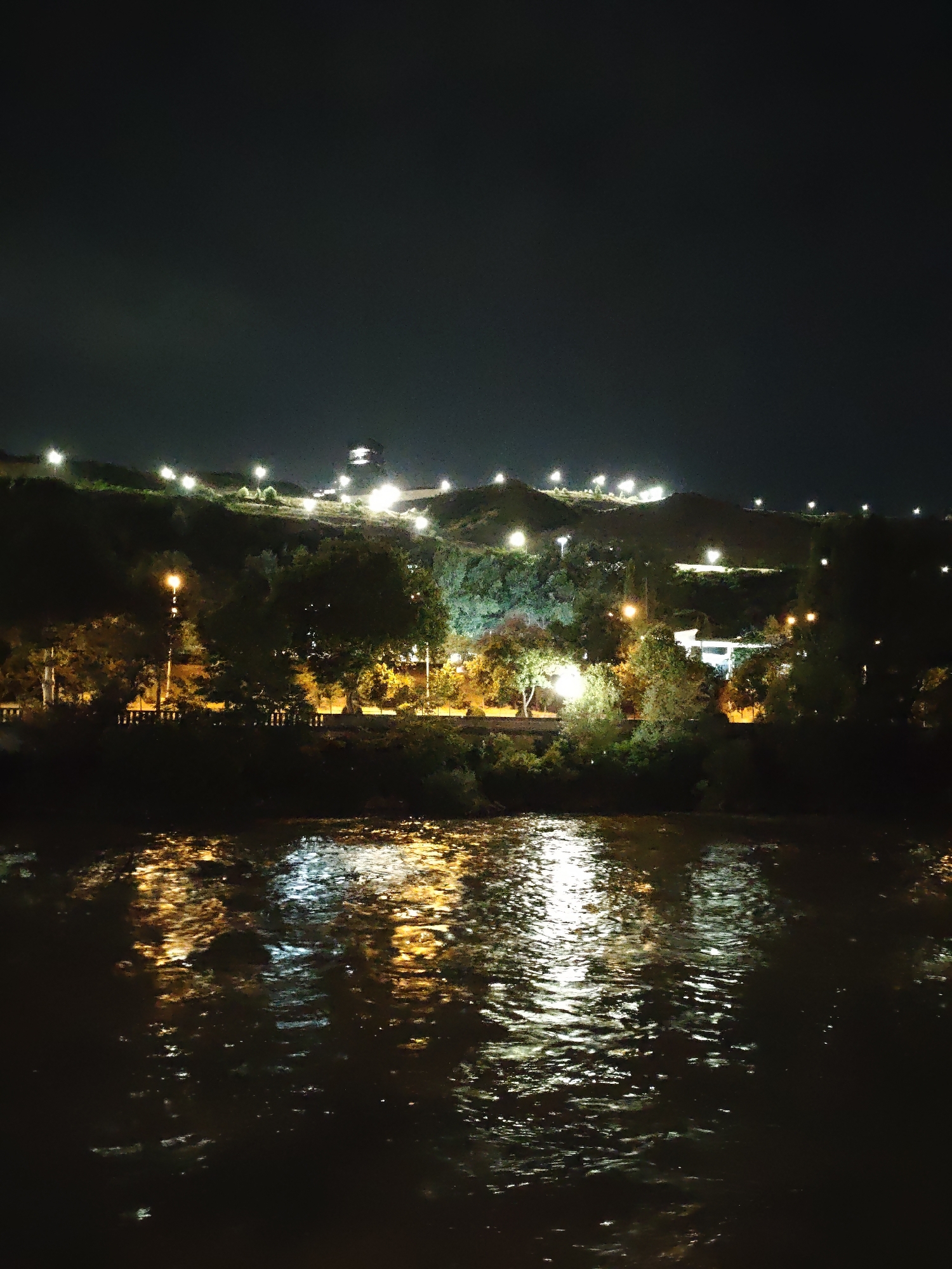 Tbilisi at night: riverfront, apartments, and lit-up streets