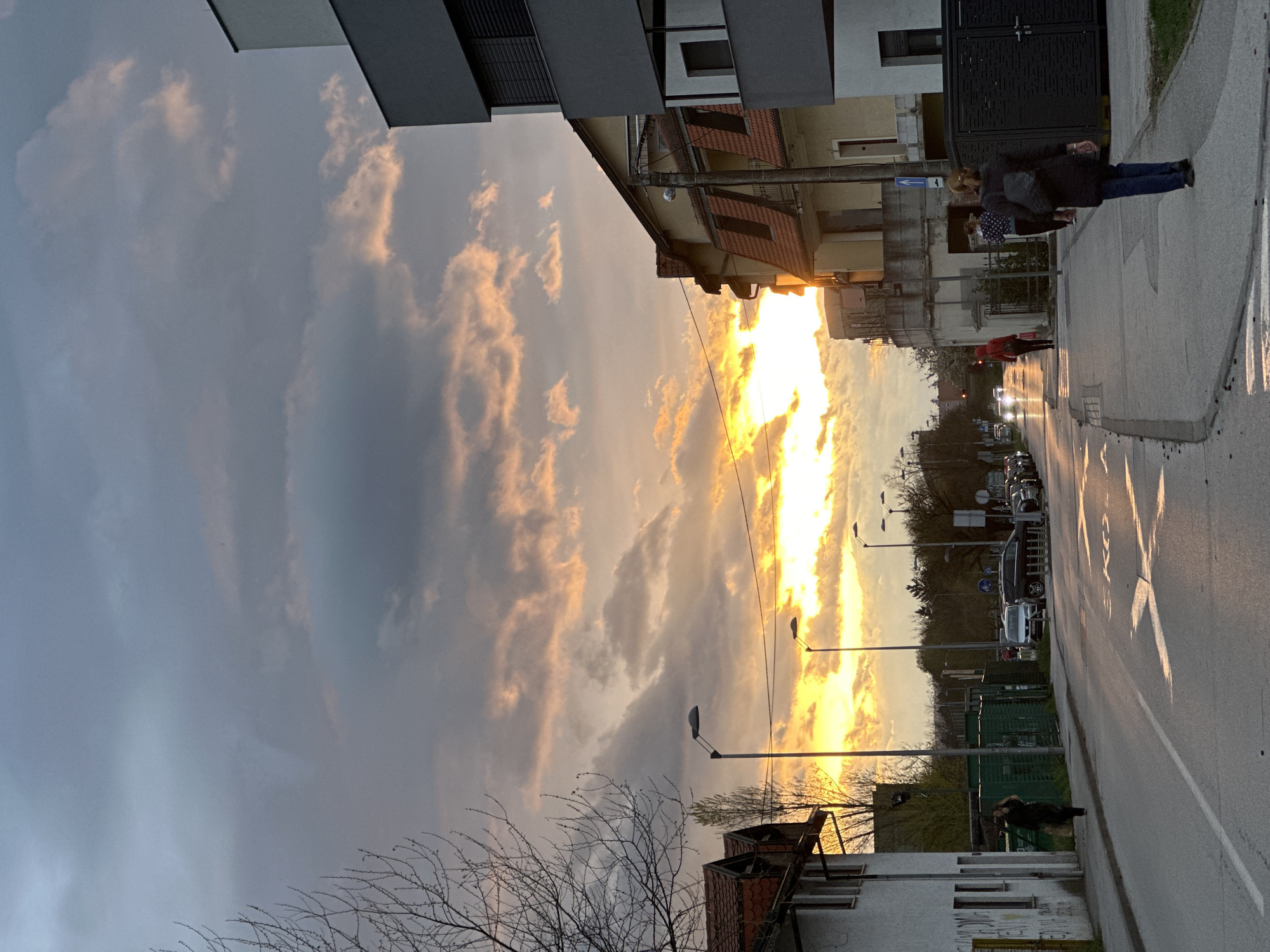 Dramatic sunset illuminates Zagreb street scene with storm clouds