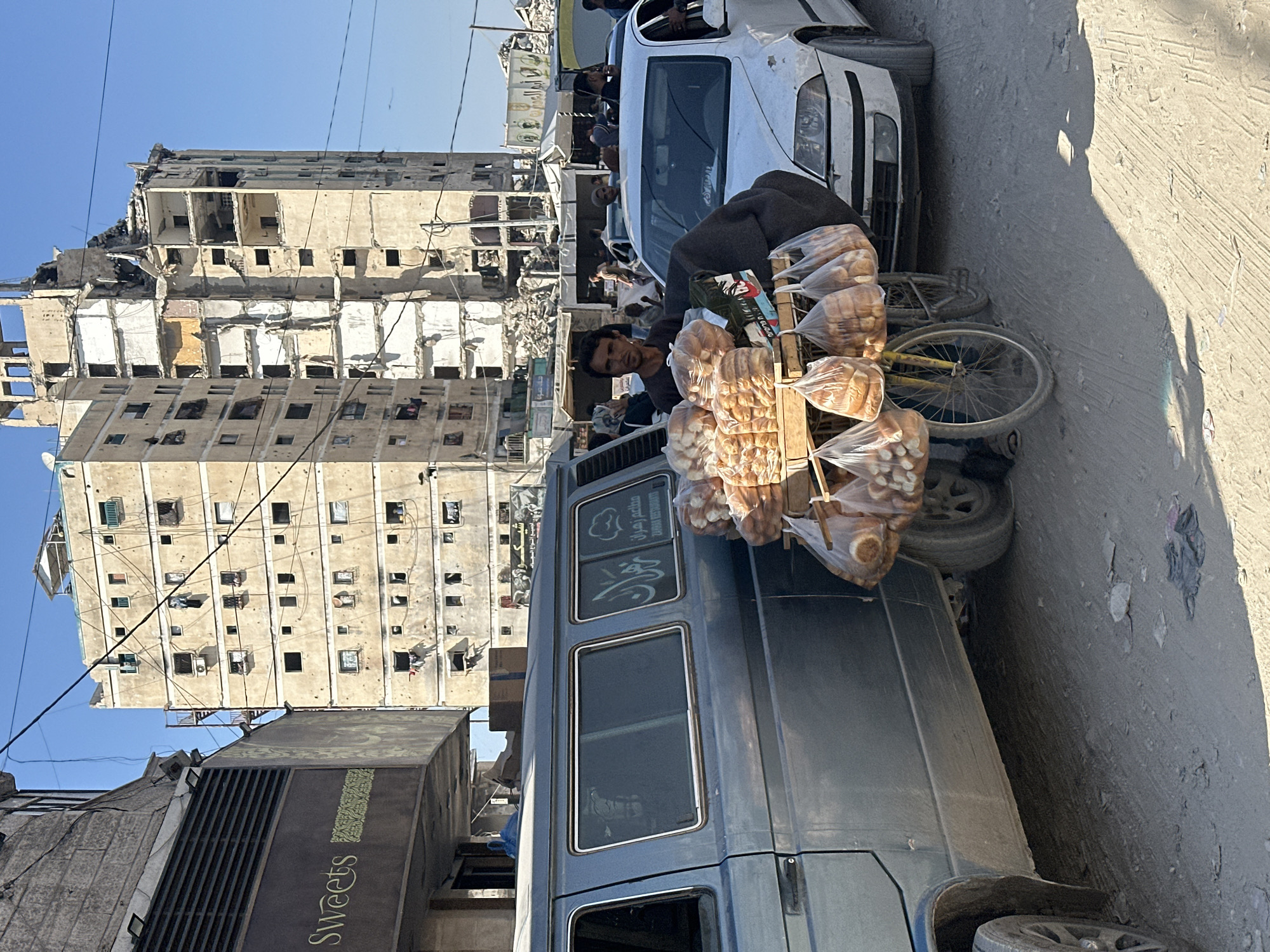 Street vendor sells bread from bicycle cart in Gaza City