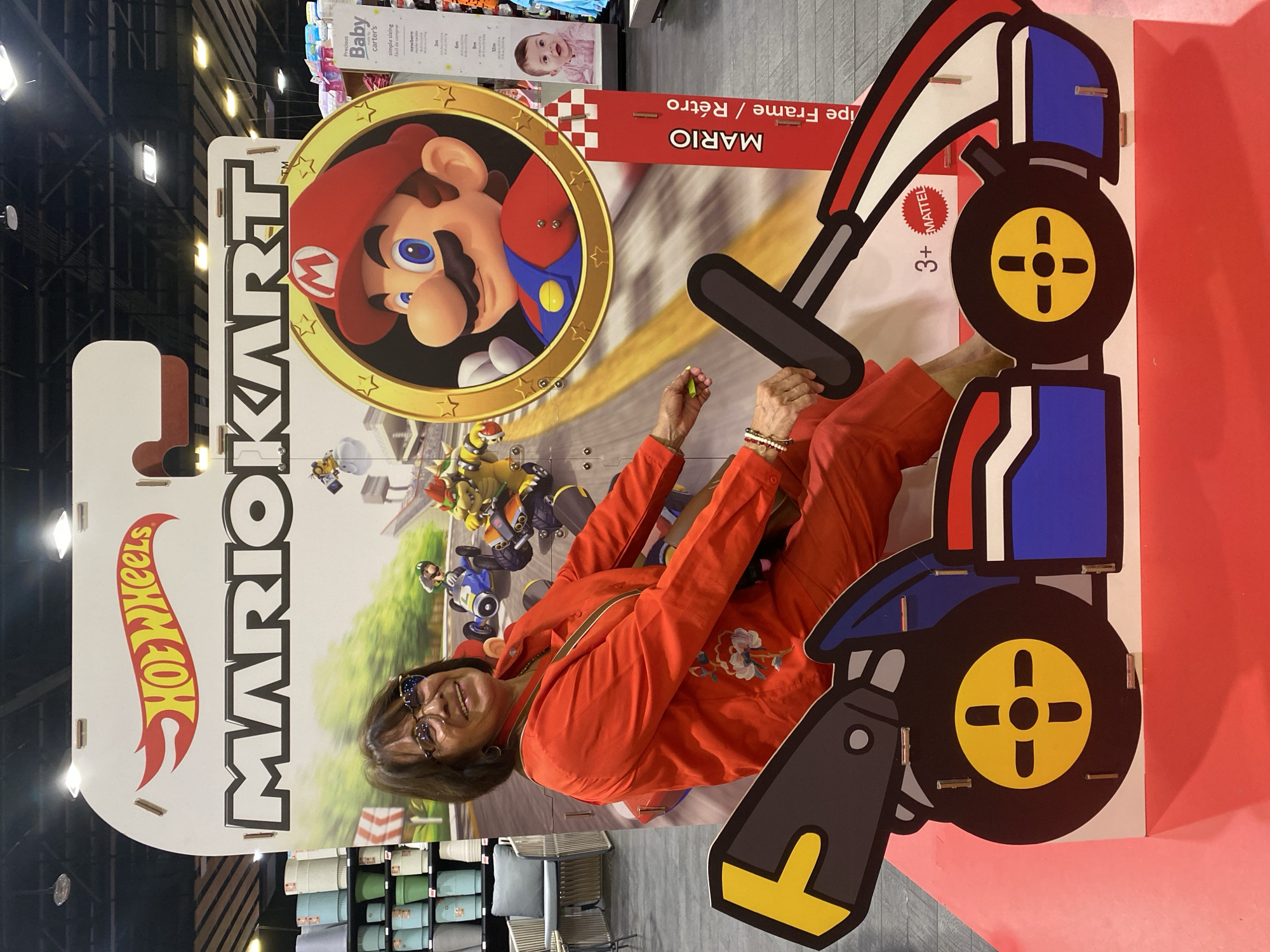 Woman poses with Mario Kart advertisement in Mexico