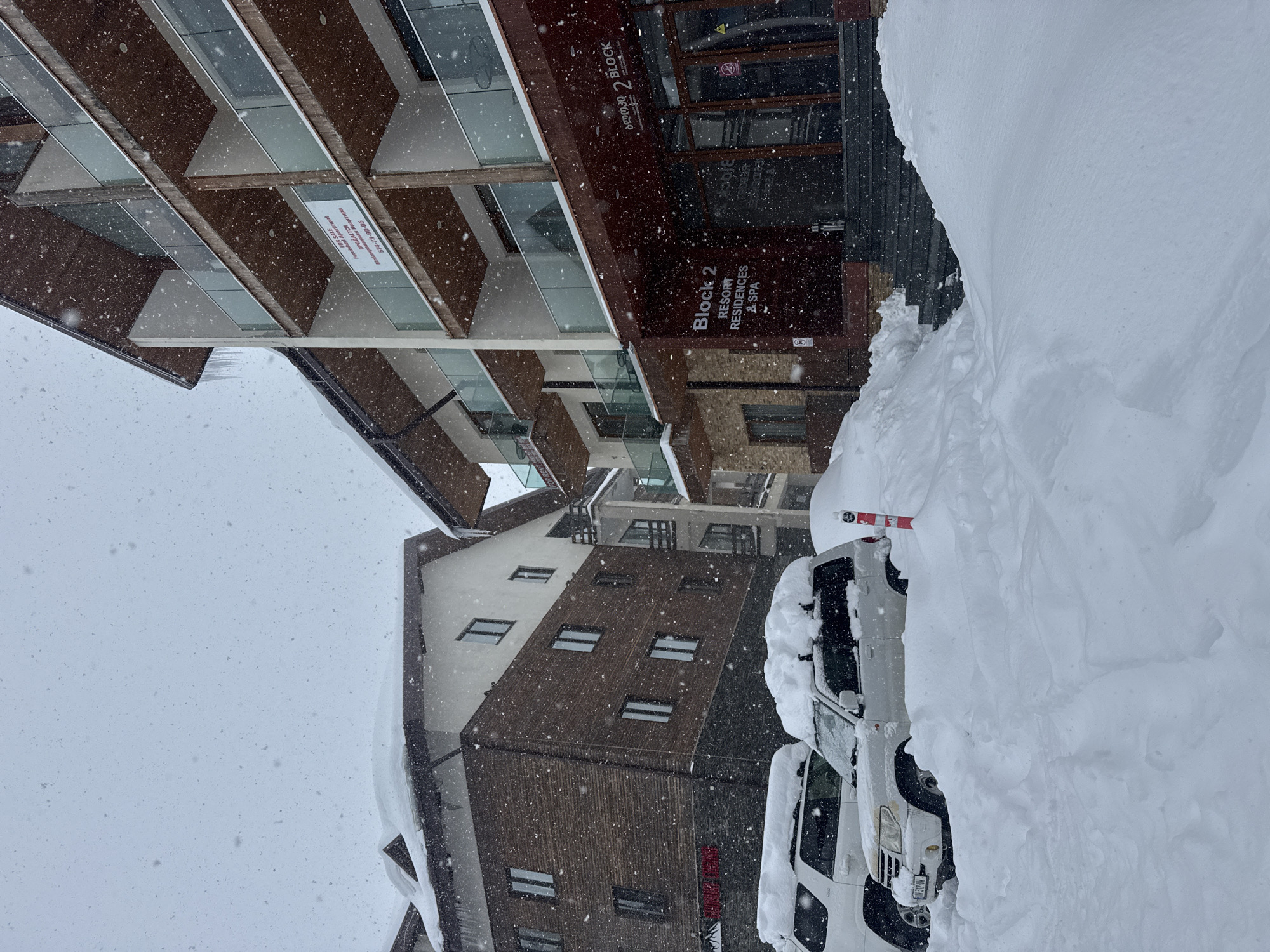 Heavy snowfall blankets mountain resort during morning hours