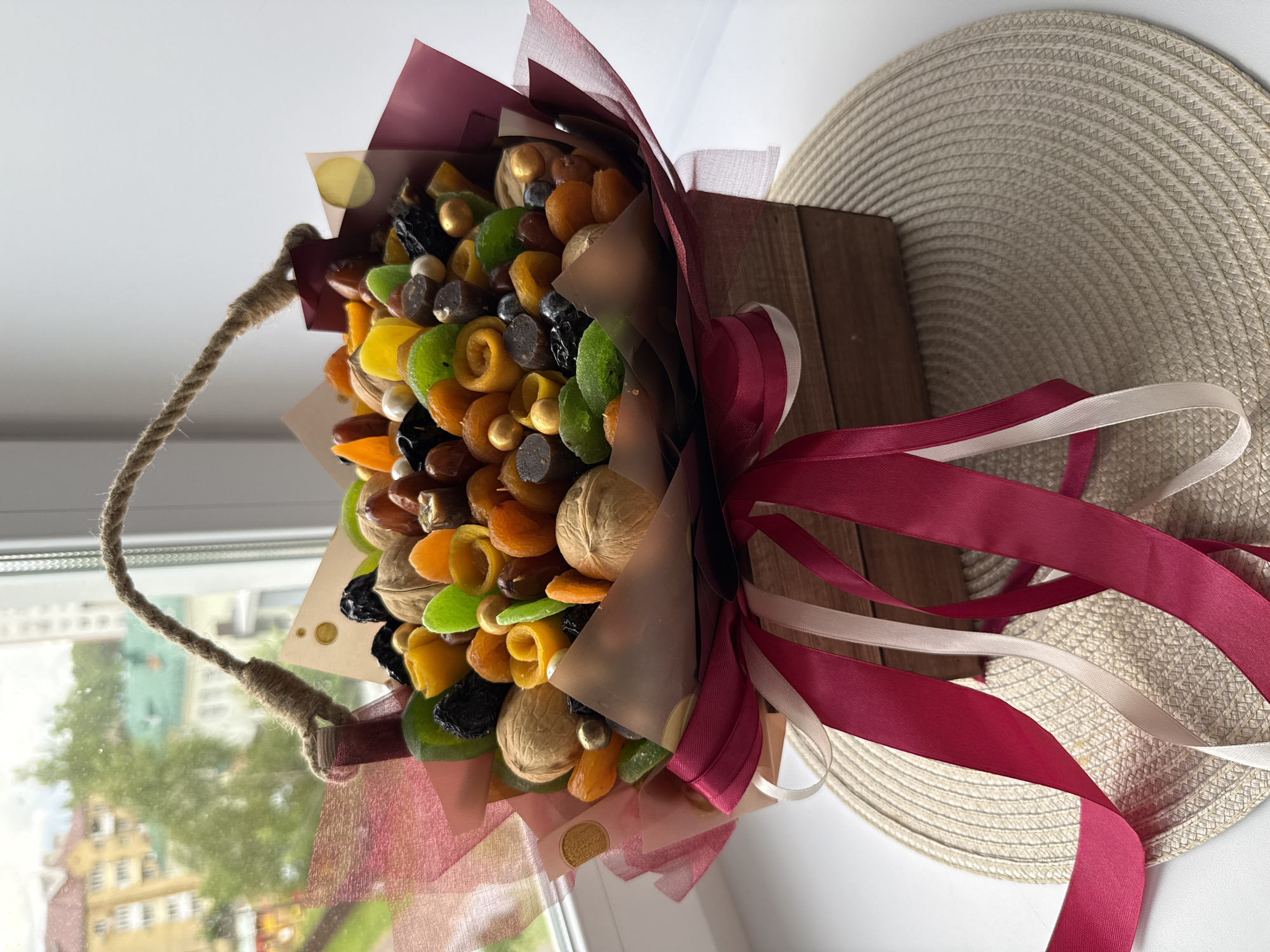 Person displays dried fruit bouquet in decorative wooden box