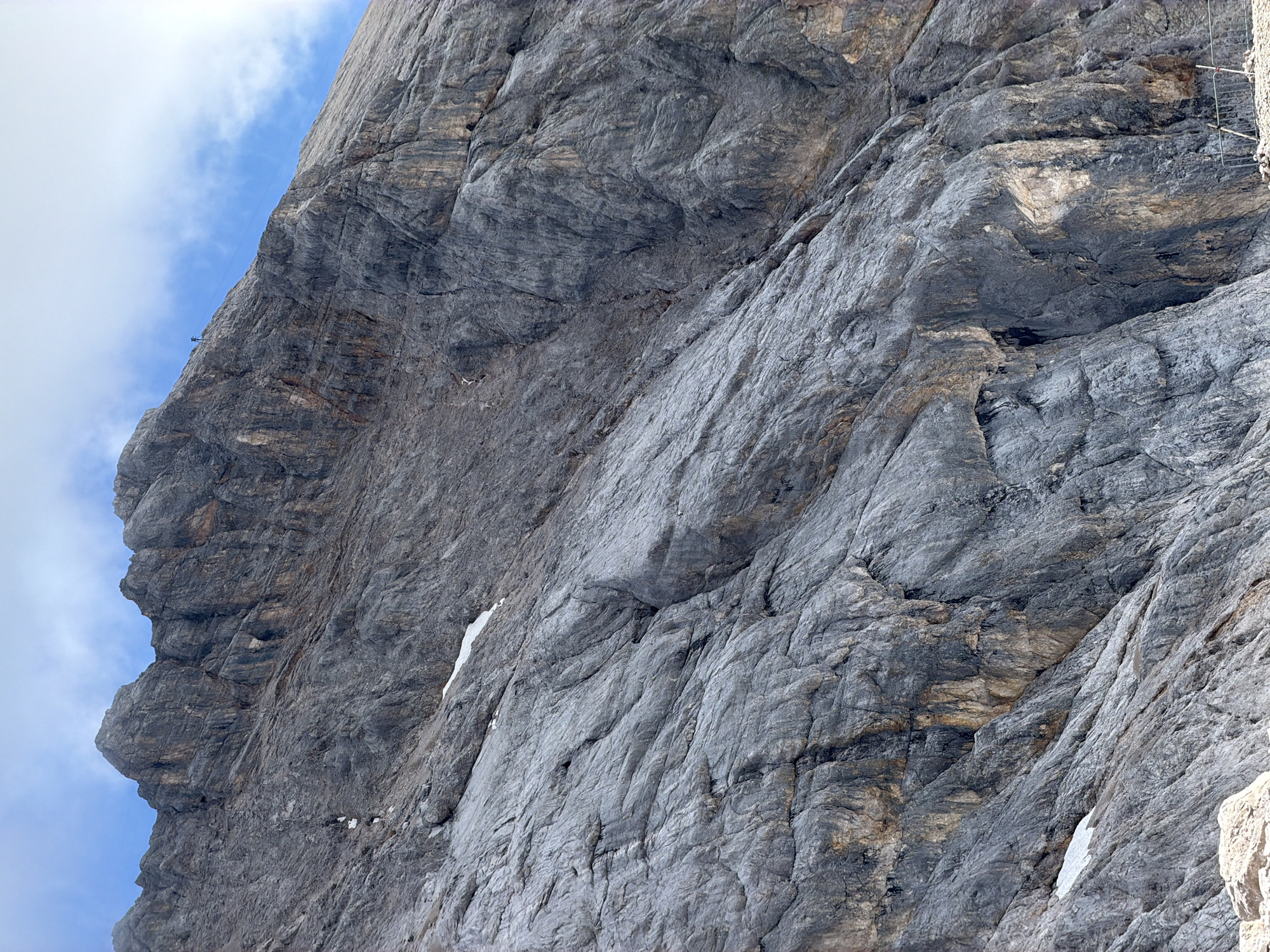 Cable car cutting across a rocky Alpine face in Wildermieming