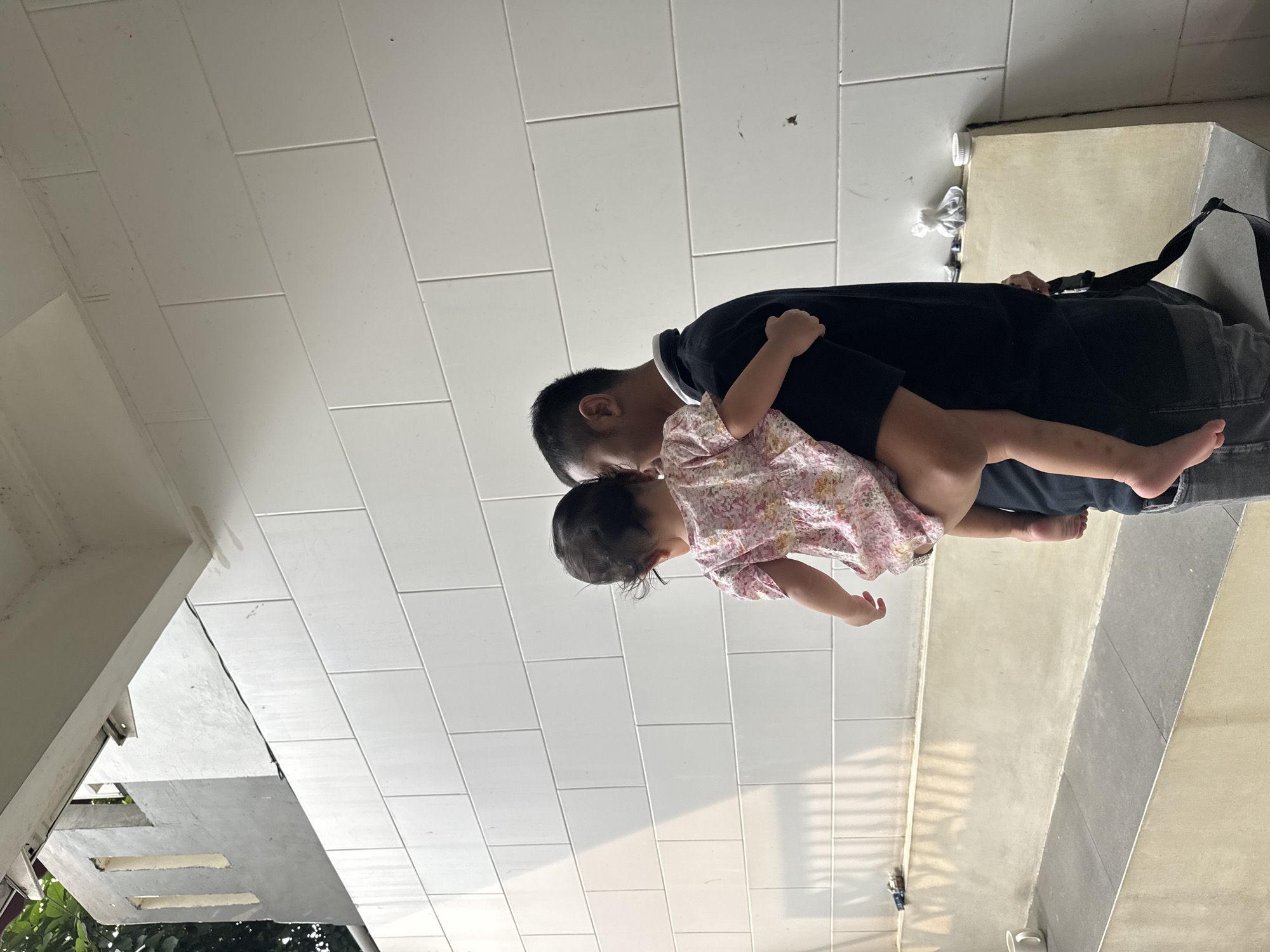 Man carries distressed child in Bekasi residential area