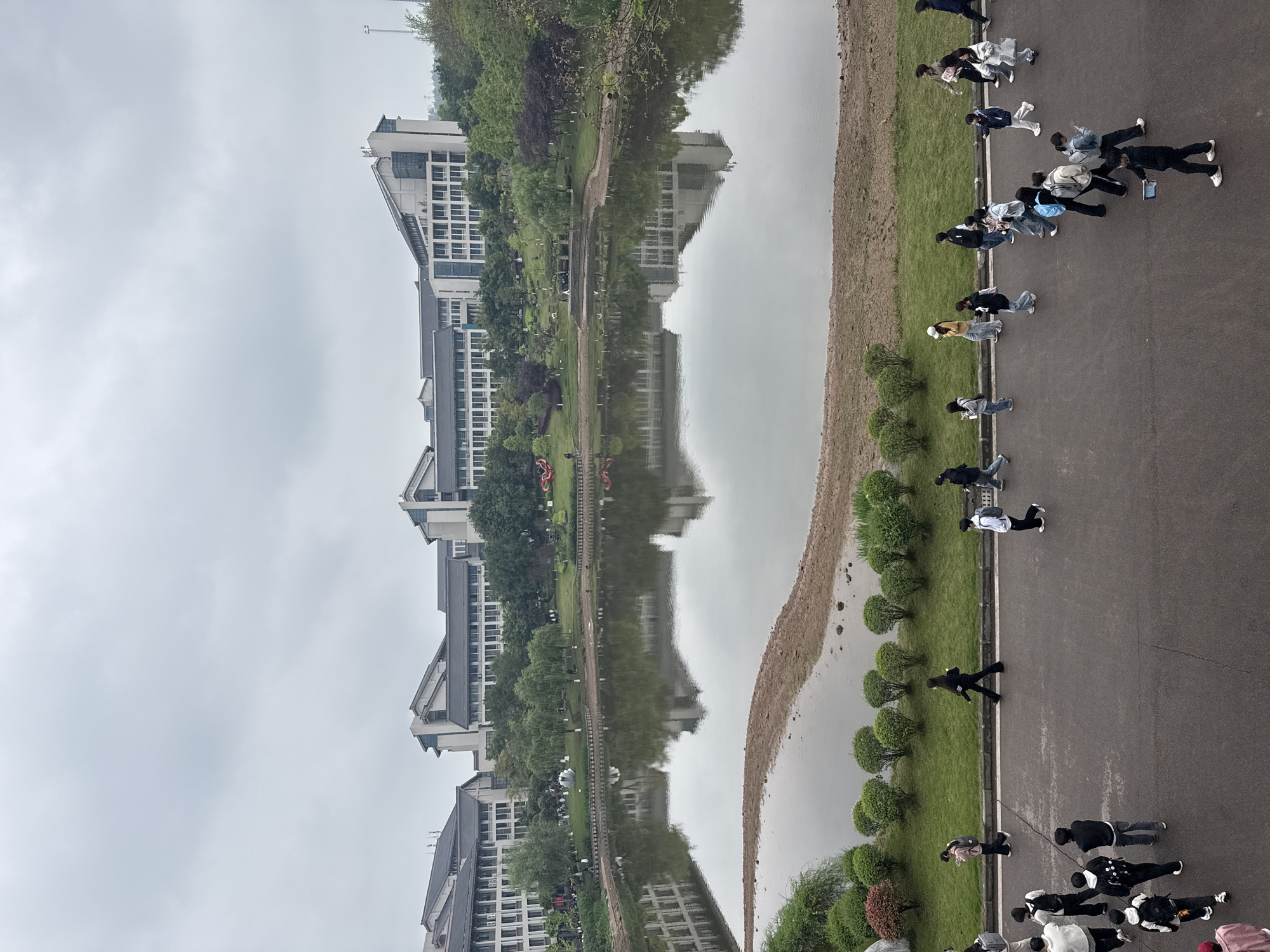 People stroll waterfront walkway in Jiangjin China