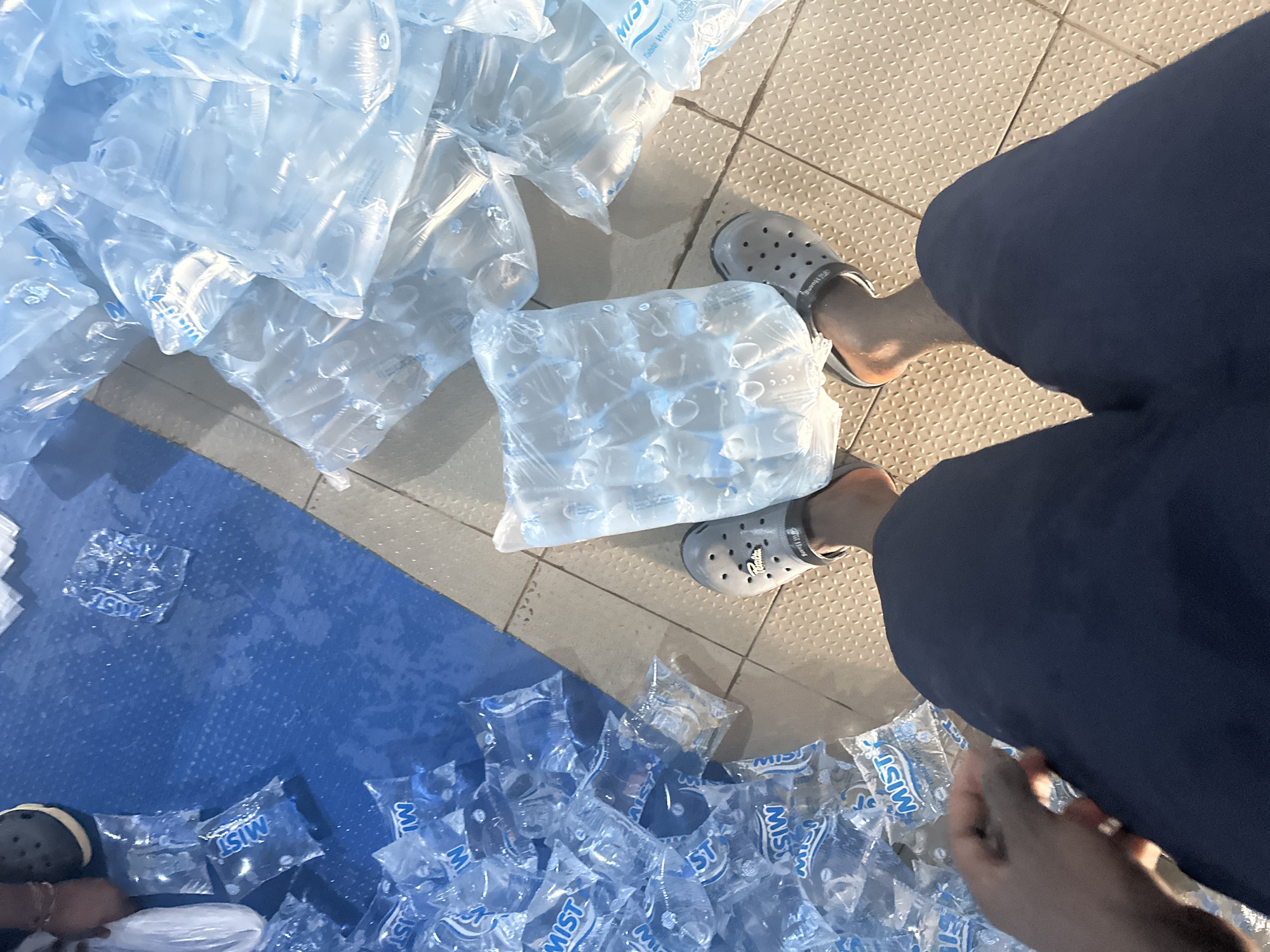 Water packaging operations and street life documented in Jos