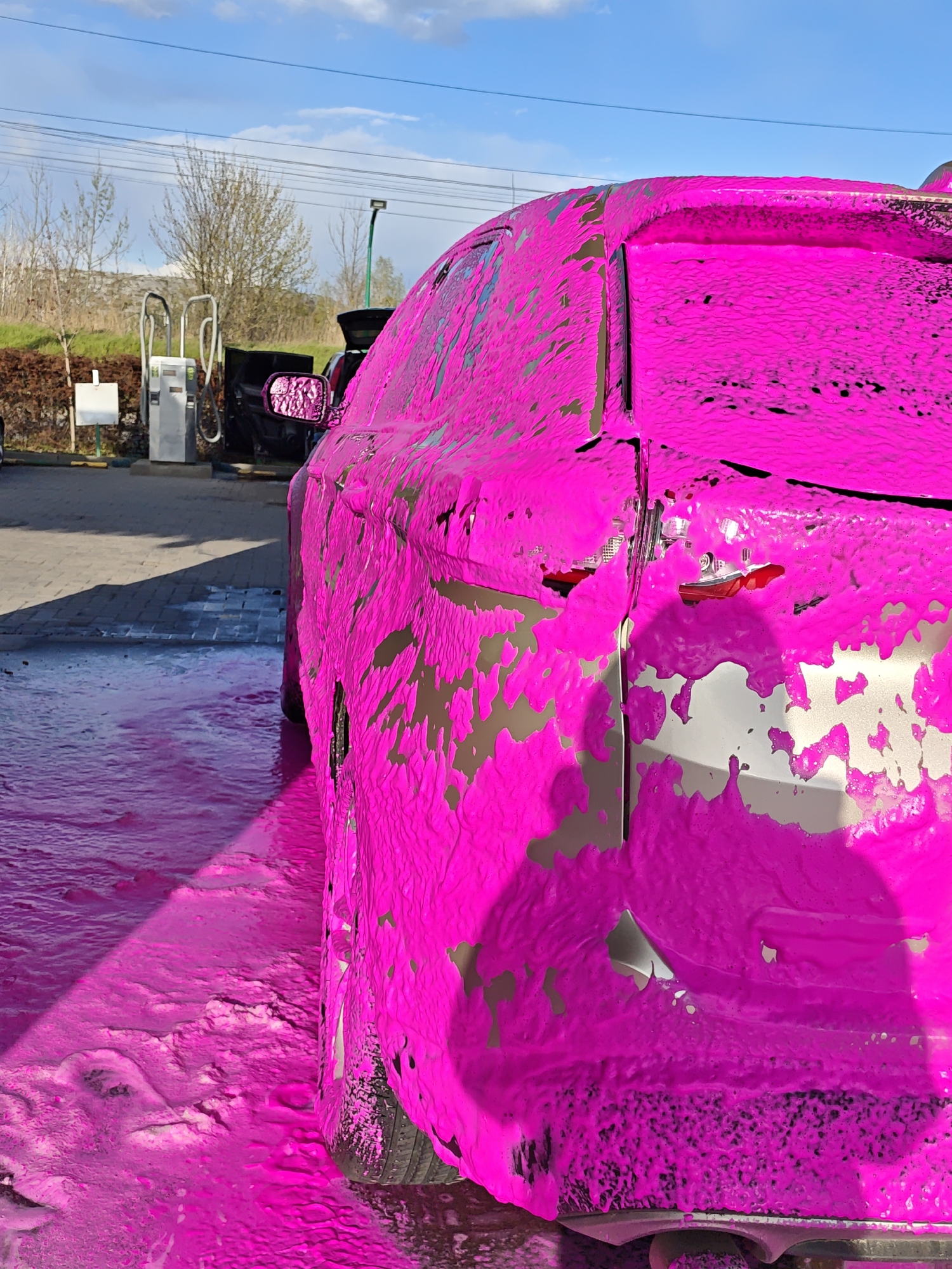 Car covered in pink foam at Vinnytsia car wash