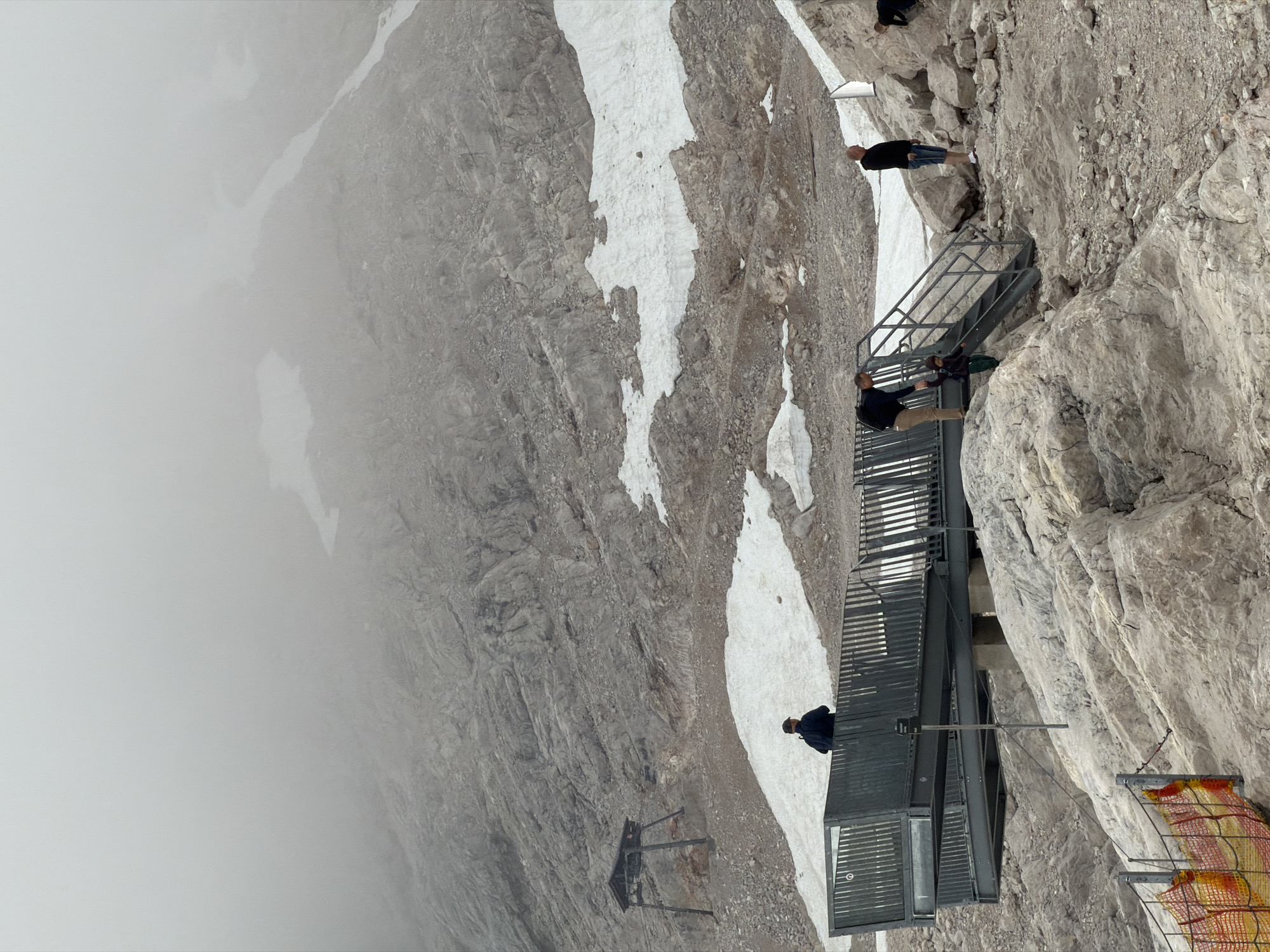 Morning on the Zugspitze: fog, snow patches, and a mountain chapel