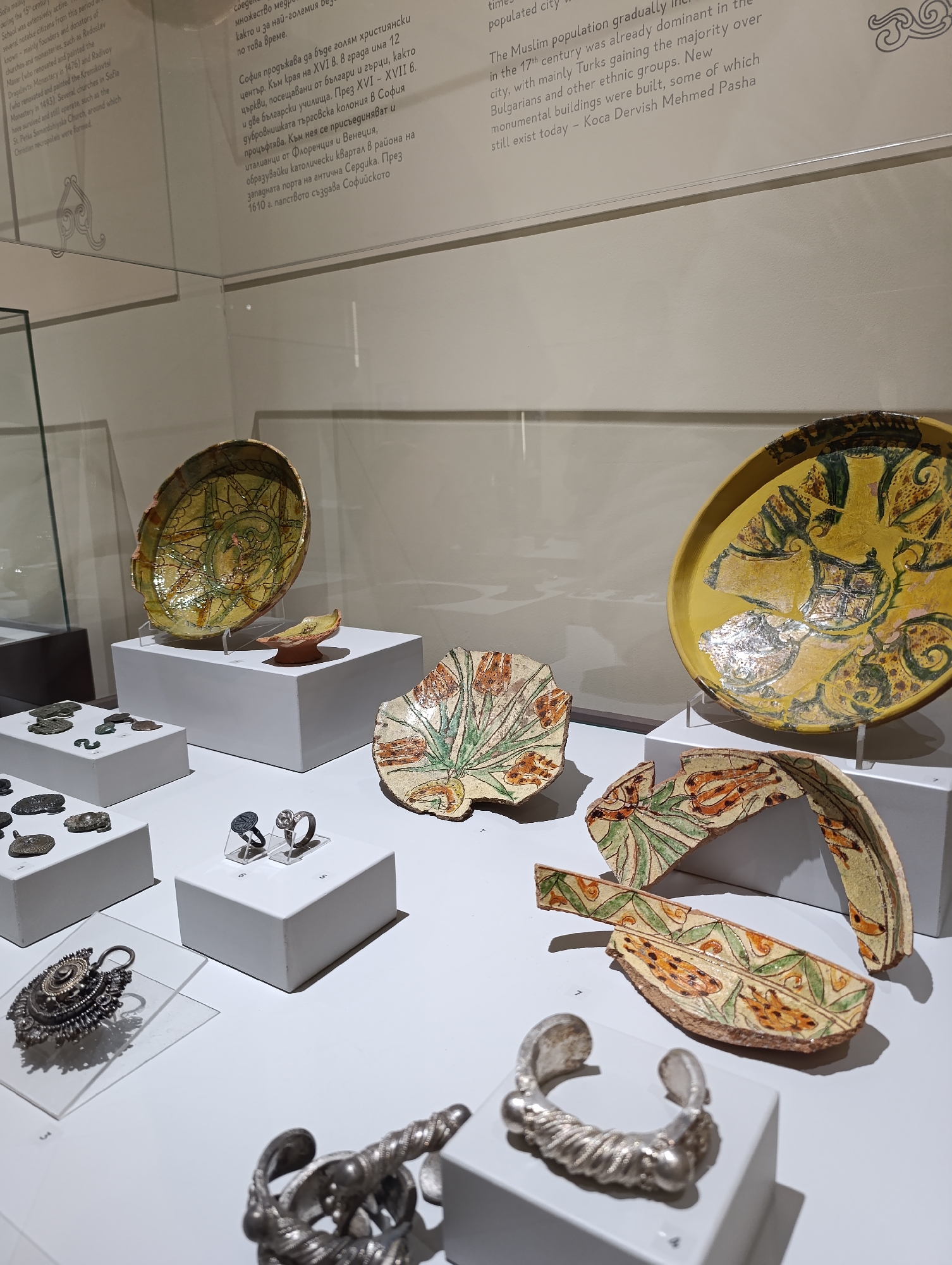 Museum archaeological exhibit displays pottery and metal artifacts