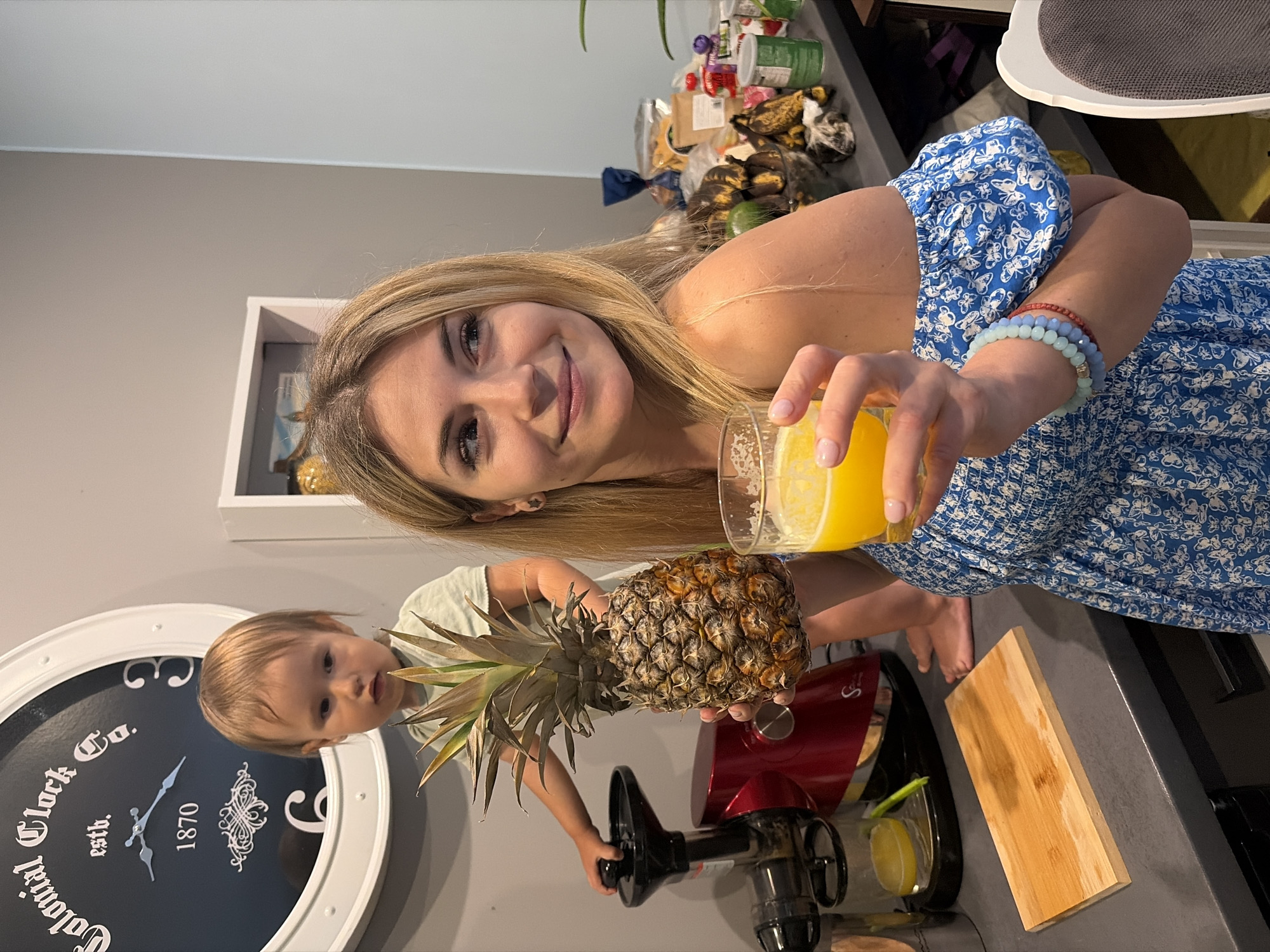 Woman prepares fresh juice with pineapple in Wisła kitchen