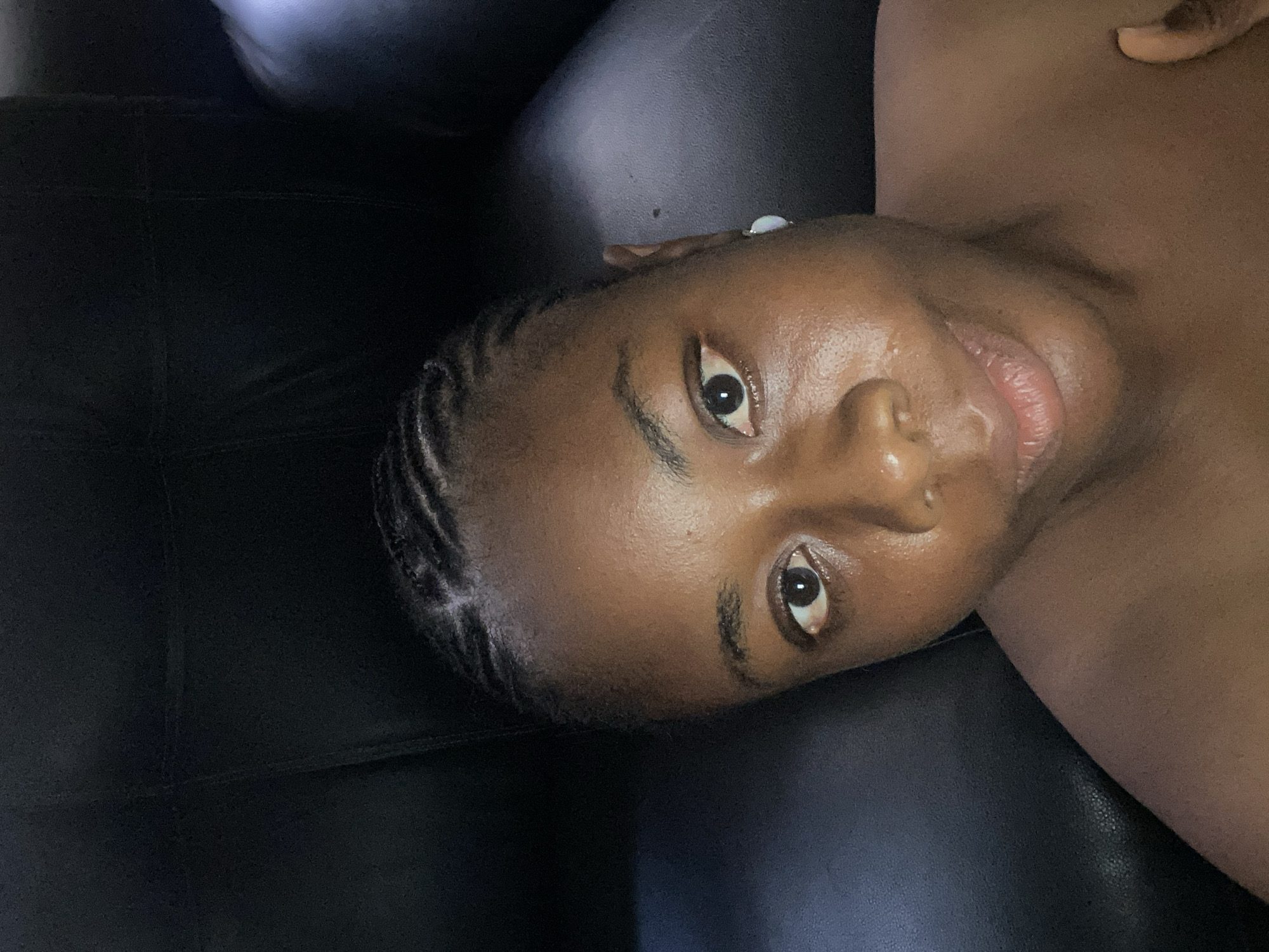 Woman photographed resting on leather couch in Lagos