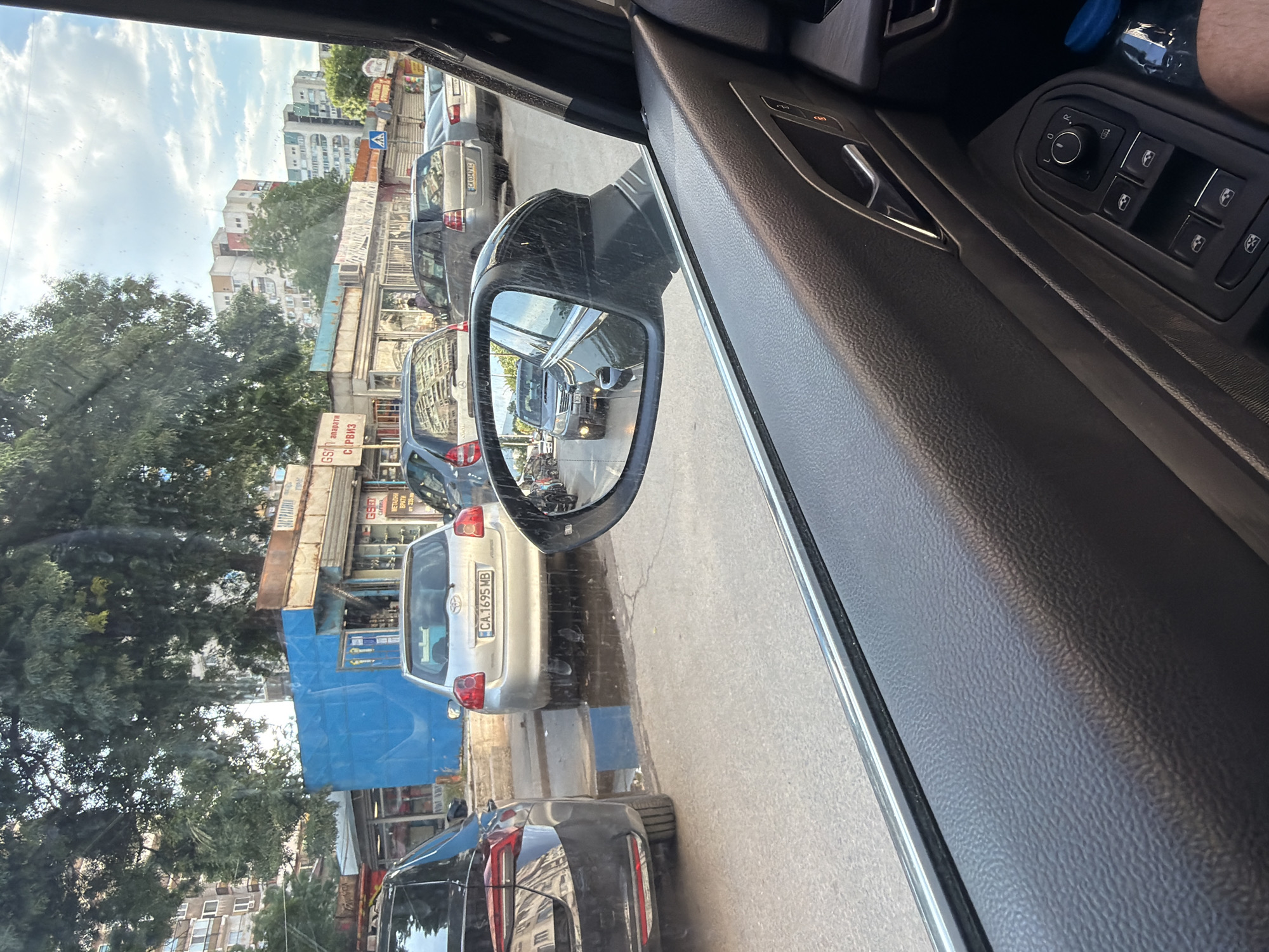 Car journey documented through Sofia streets, passenger photographed