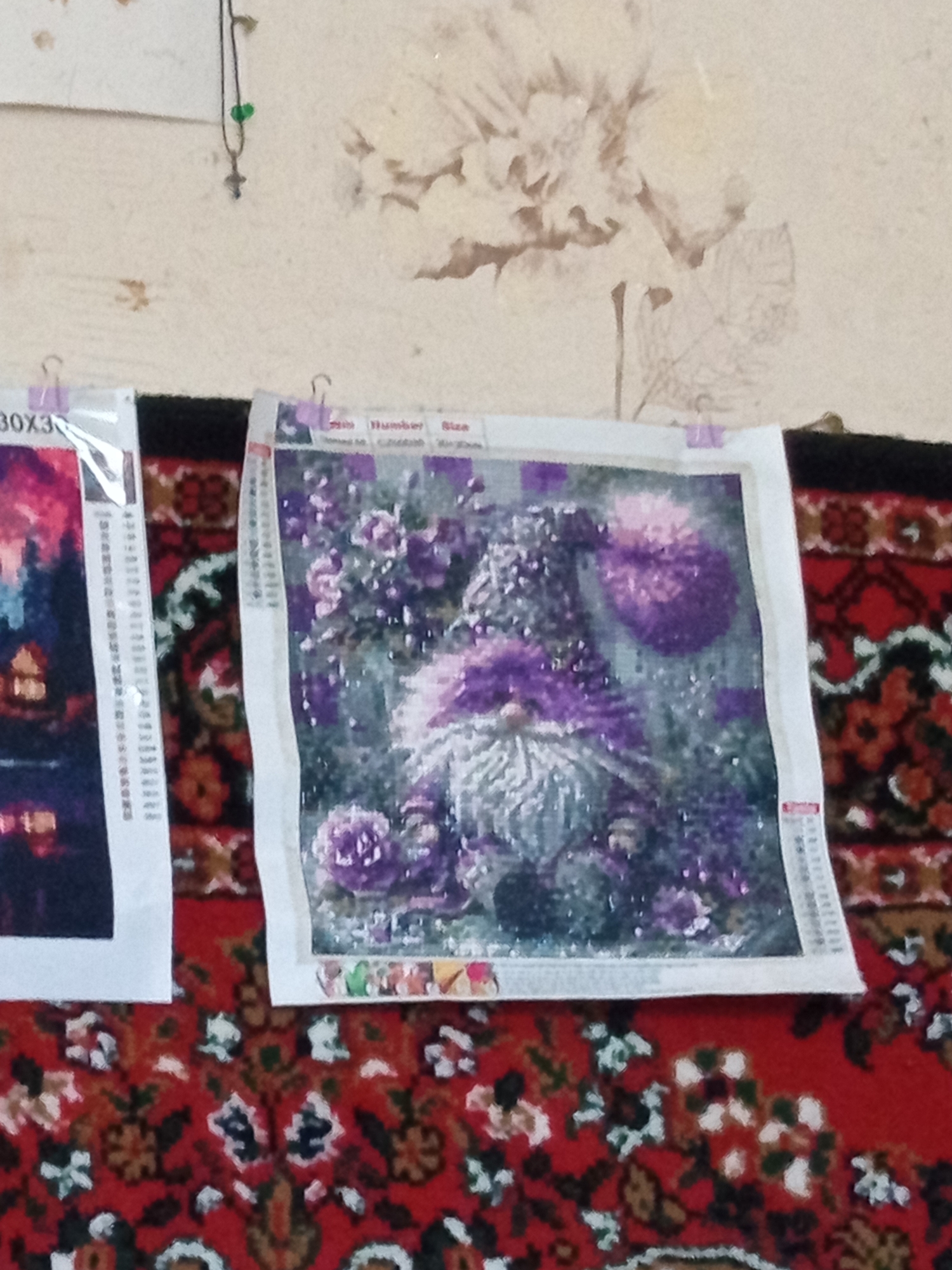 Diamond painting collection on display, finished and in progress