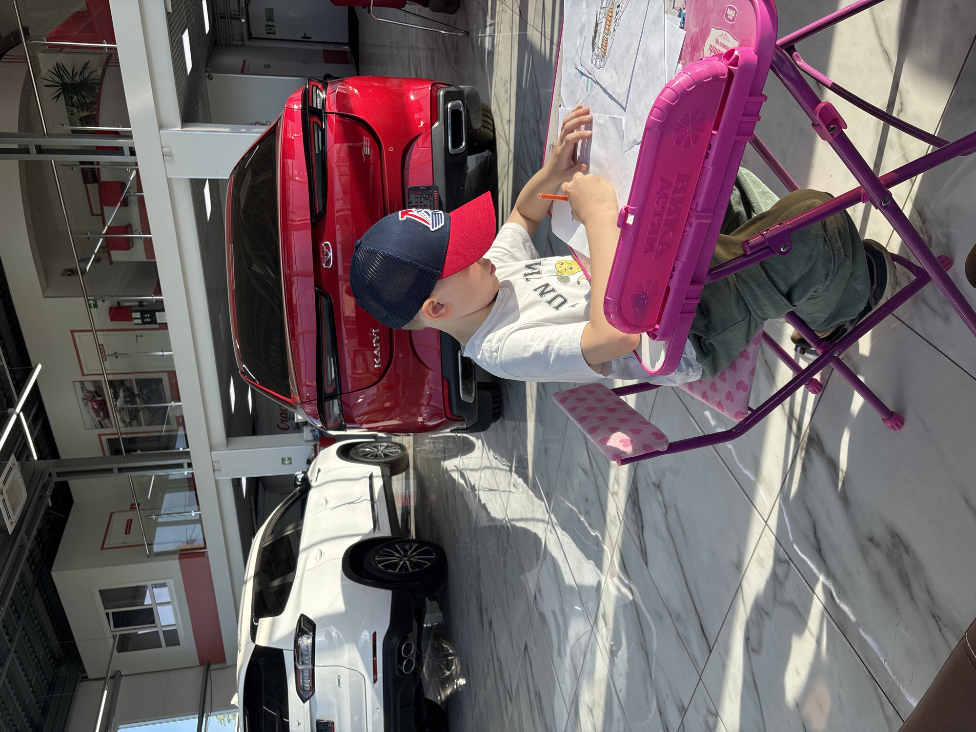 Family visits car dealership in Yaroslavl, Russia