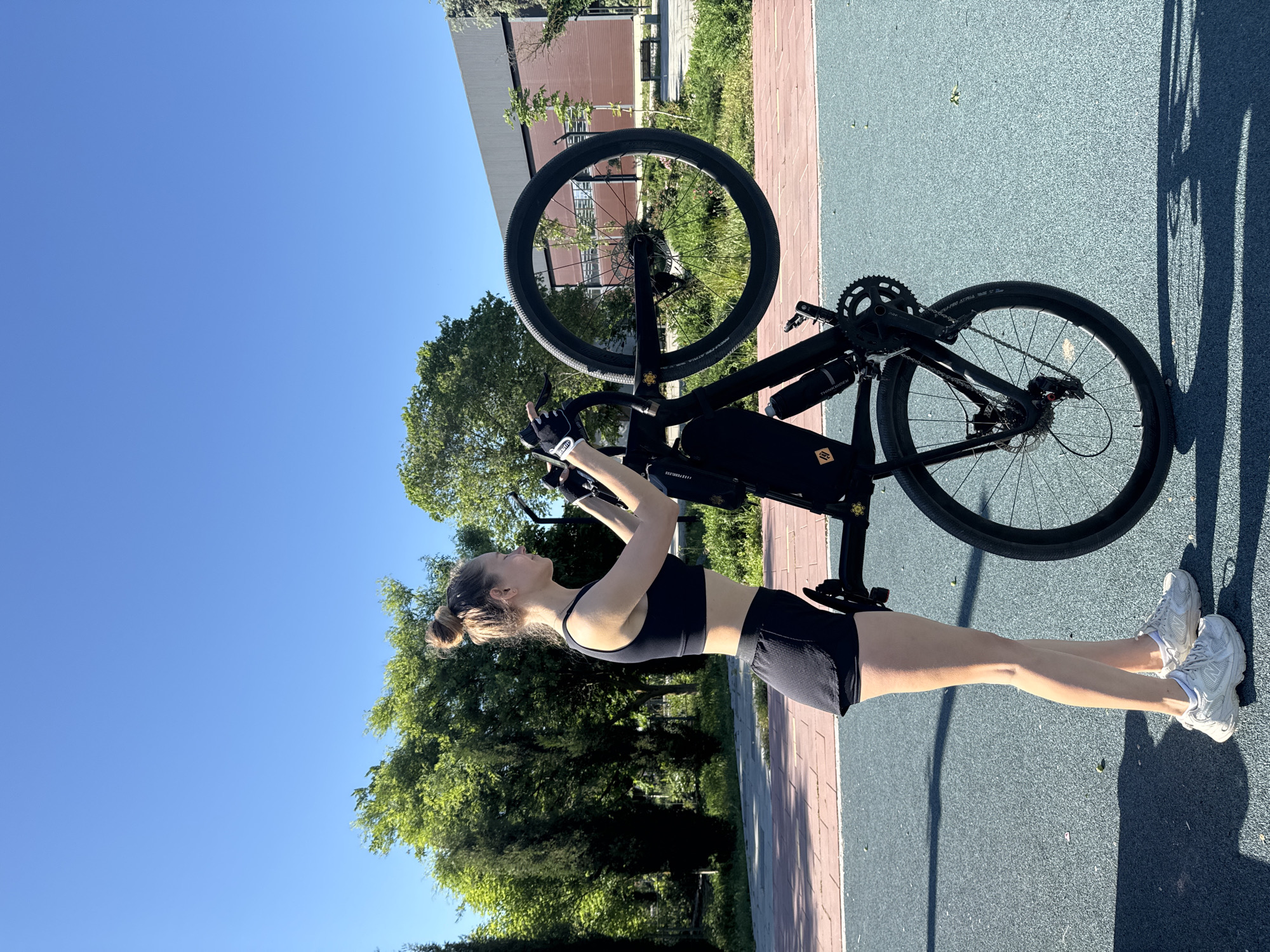 Woman poses with bicycles during early morning workout in Ukraine