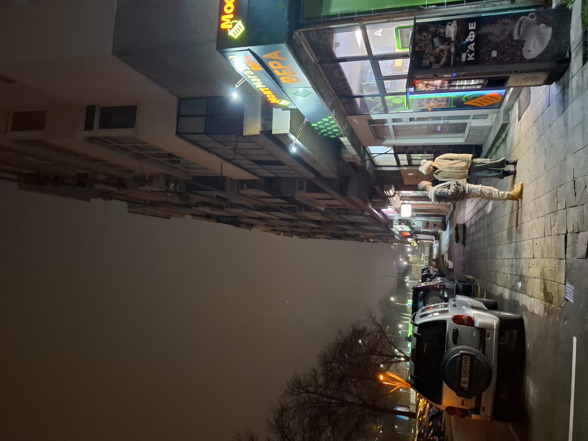 Evening pedestrians spotted near North Market storefront in Varna