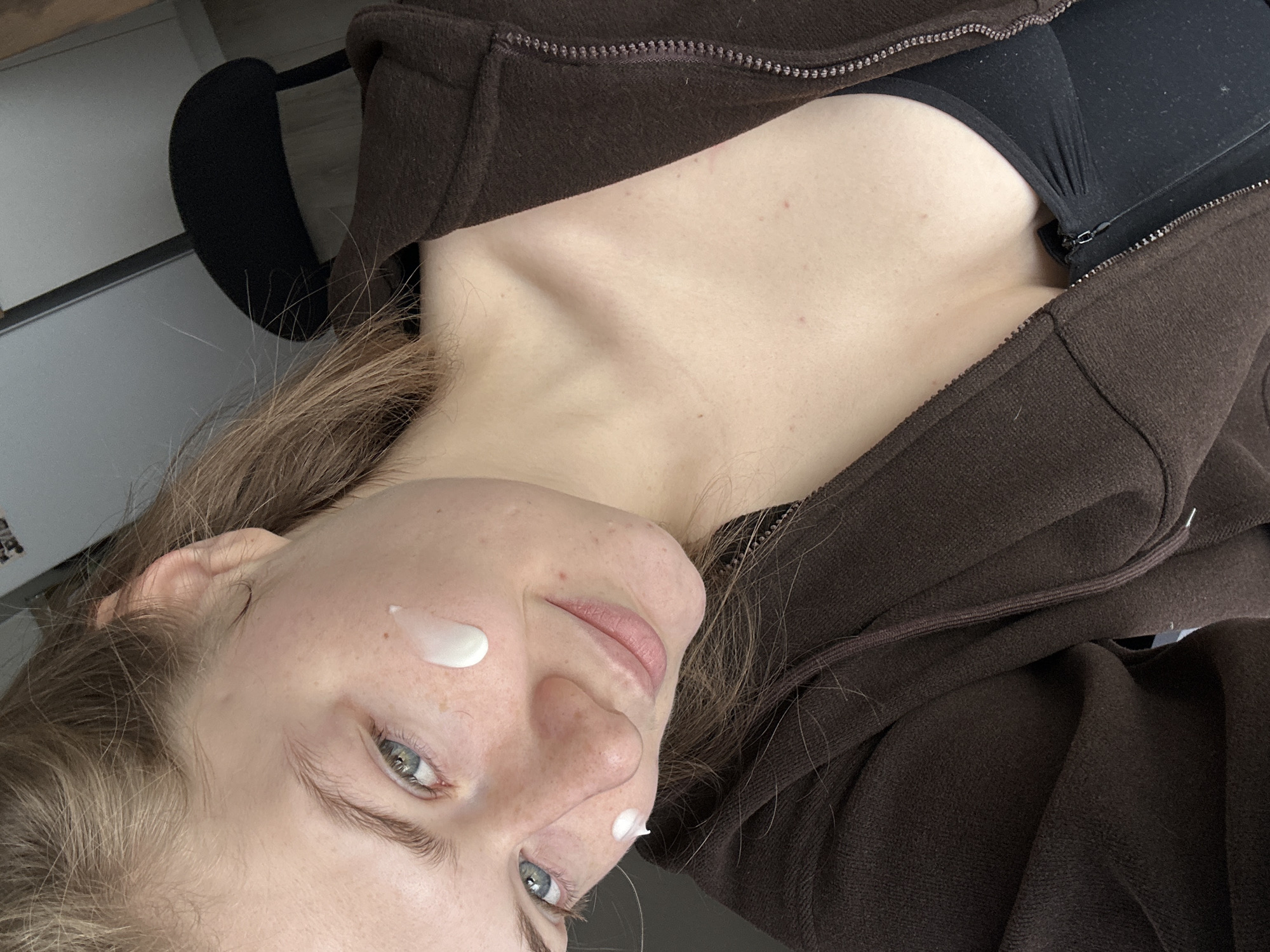 Morning routine captured: woman with face cream, mug in Kazan
