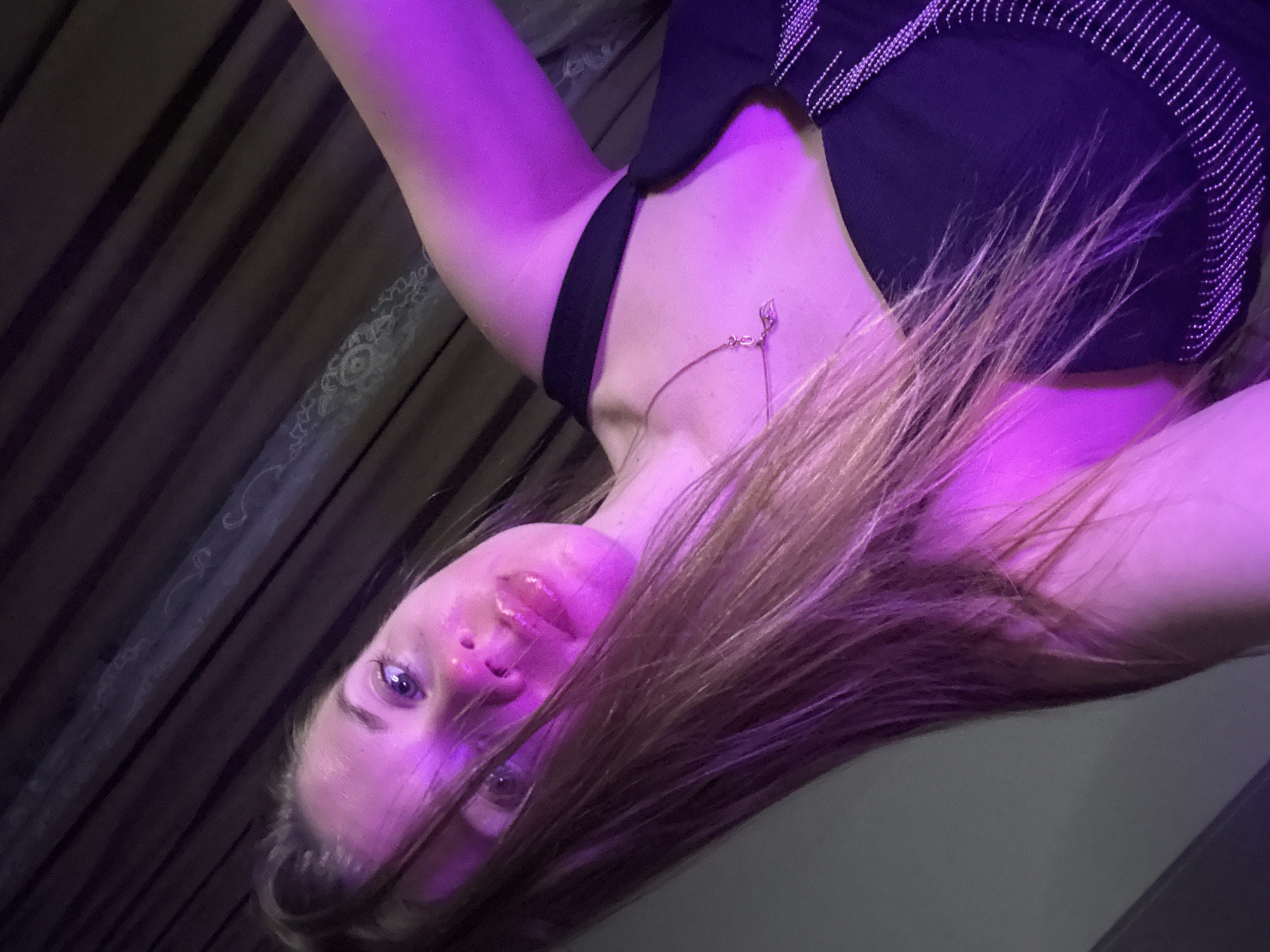 Woman photographed under purple lighting in Batumi, Georgia