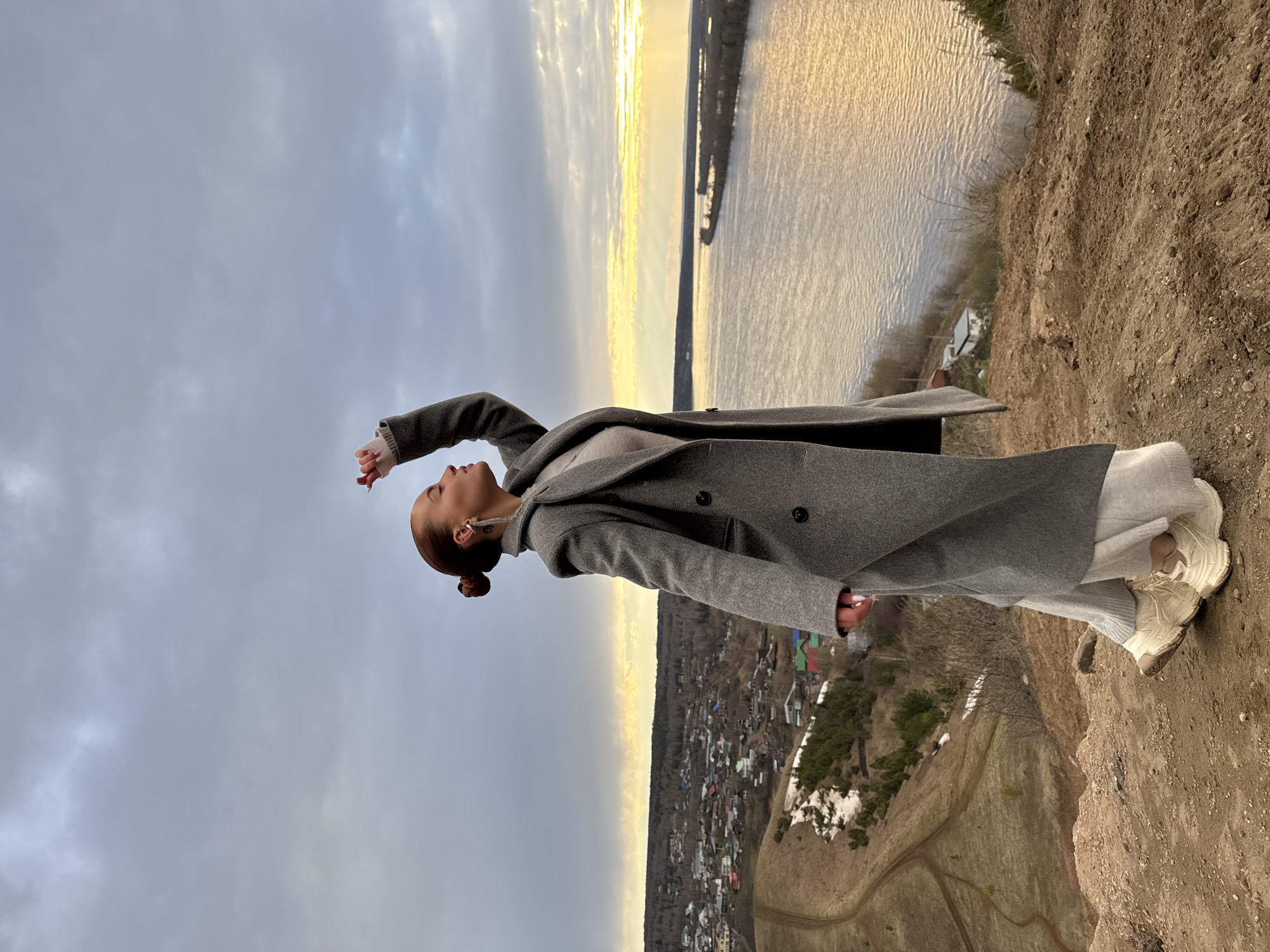 Woman photographed on cliff overlooking river in Ольховka, Russia
