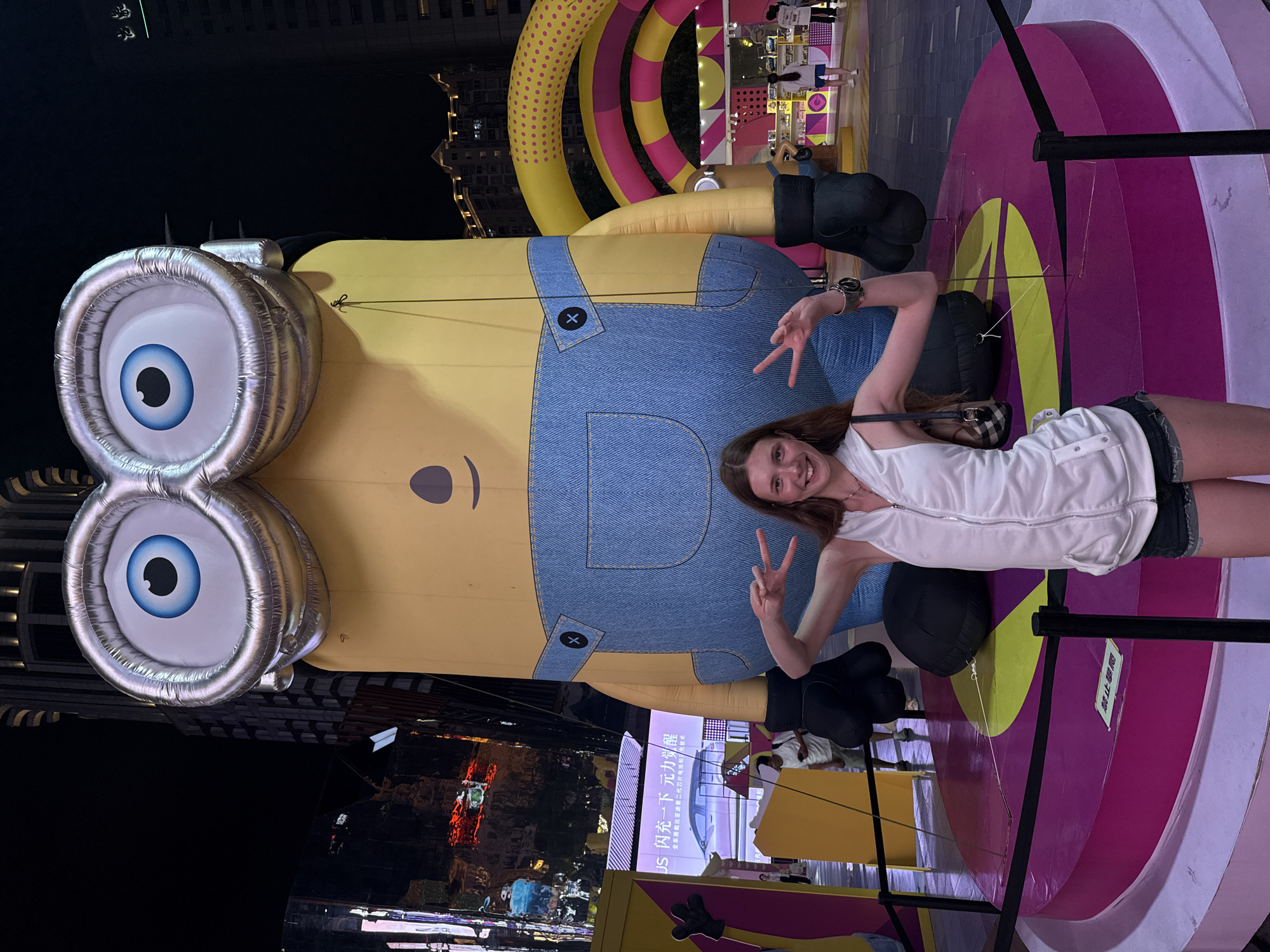 Tourists pose with giant Minion display in nighttime Shanghai