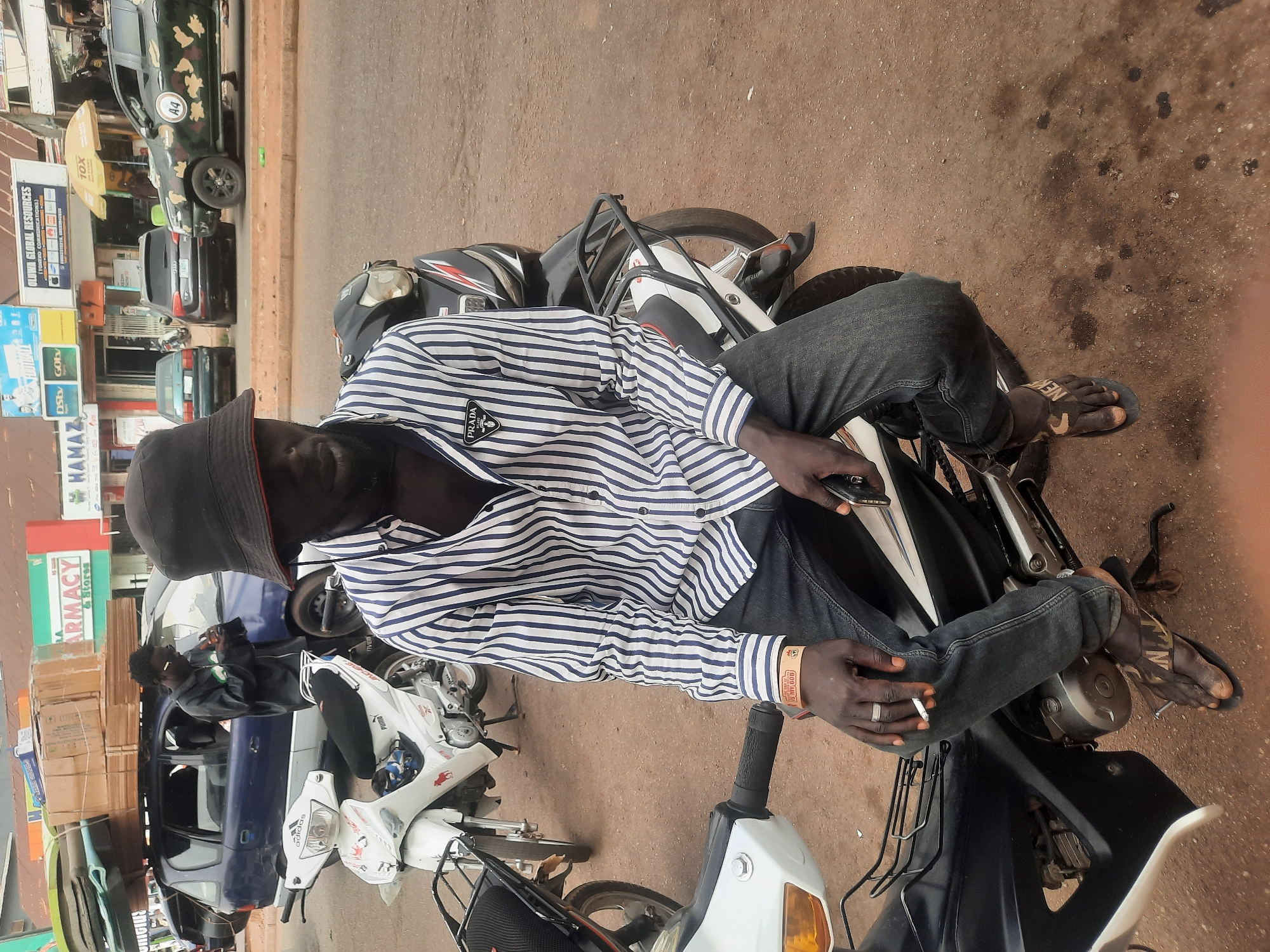 Man sits on motorcycle in Jos, Nigeria