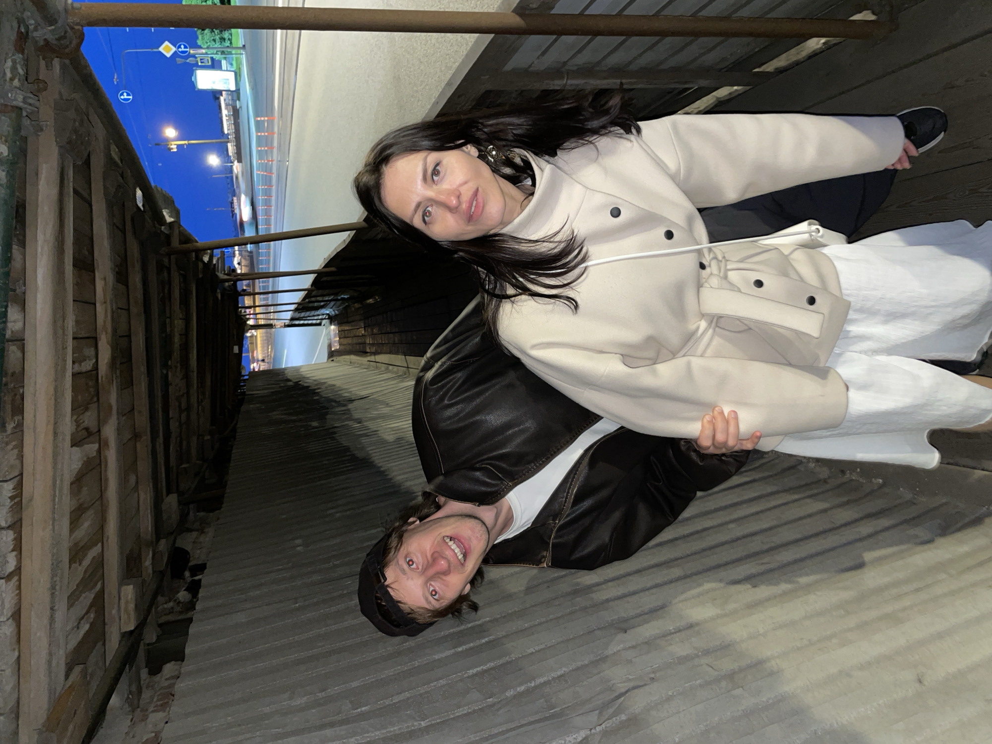 Couple poses, walks near covered walkway in Saint Petersburg