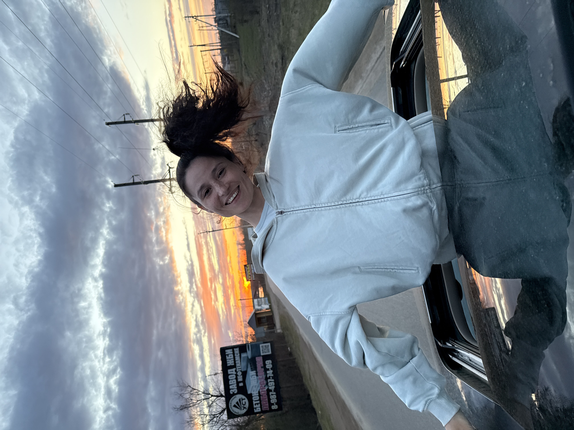 Woman enjoys car ride with wind in Dubnik