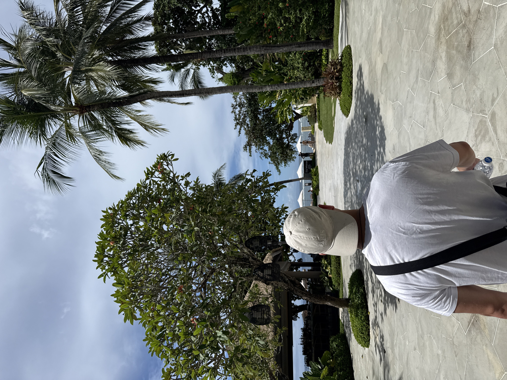 Tourist walks through resort areas in Kuta Selatan morning