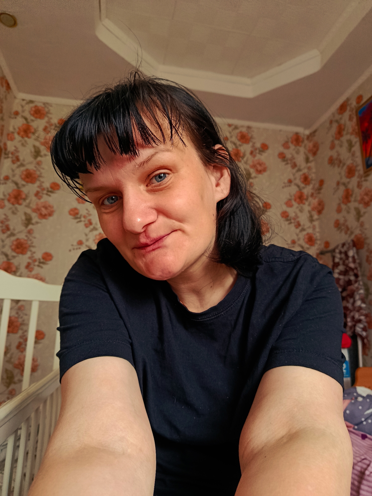Woman takes selfie with blue eyes and bangs