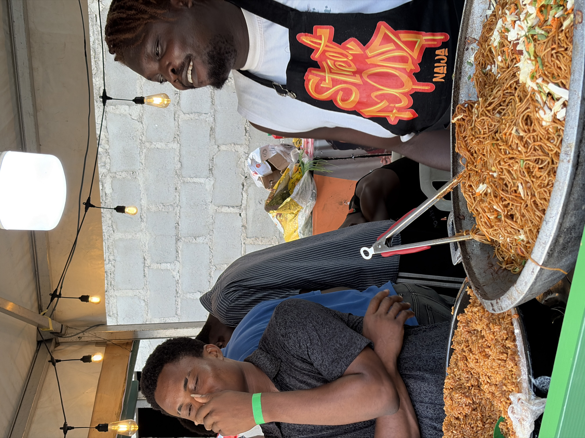 Street food vendor serves customers in Lagos