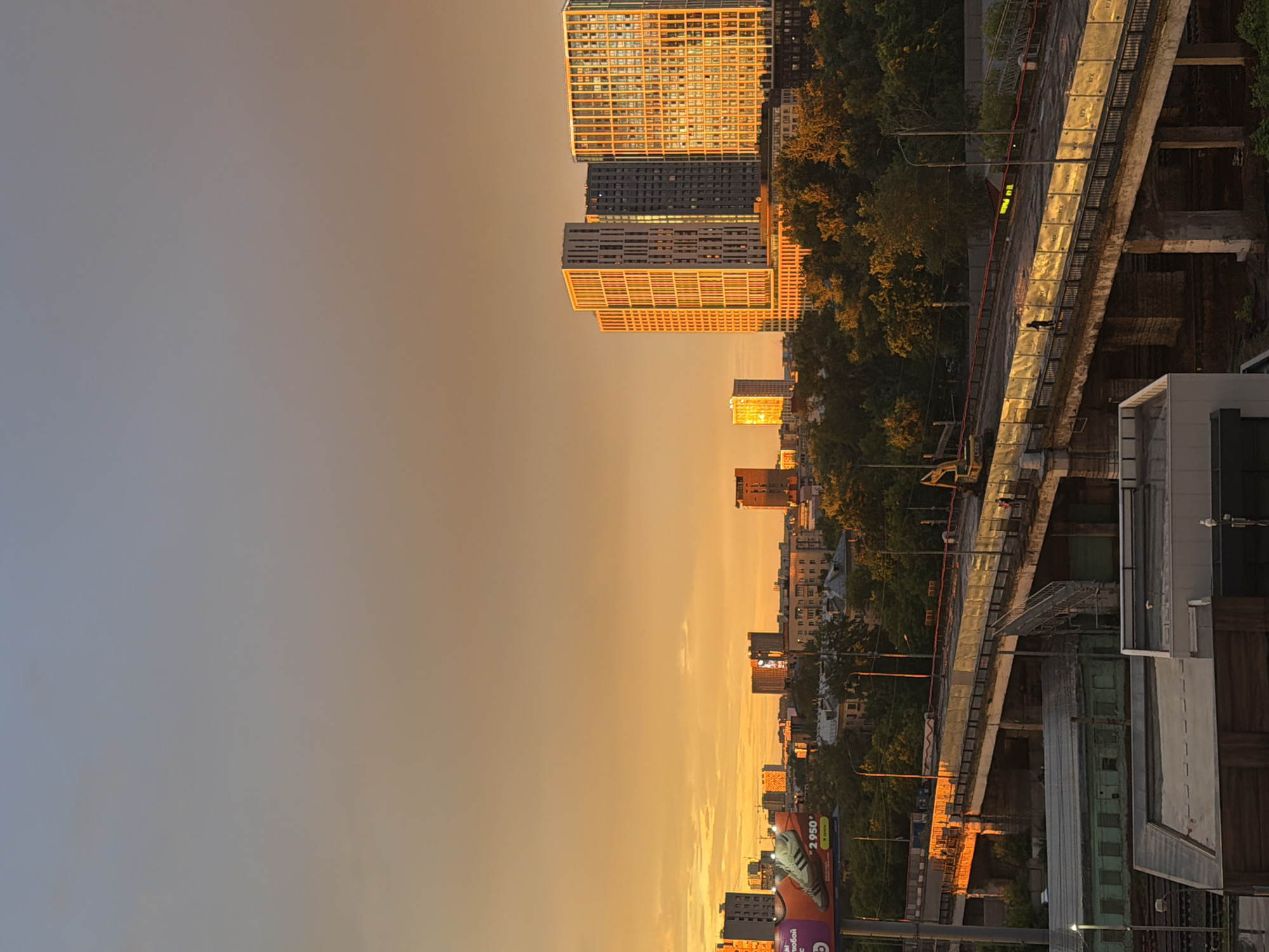 Rainbow and golden sunset over Moscow's residential skyline