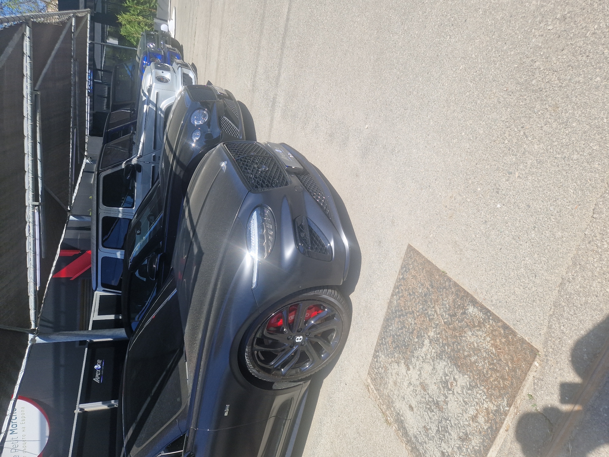Luxury car lineup spotted in outdoor parking area