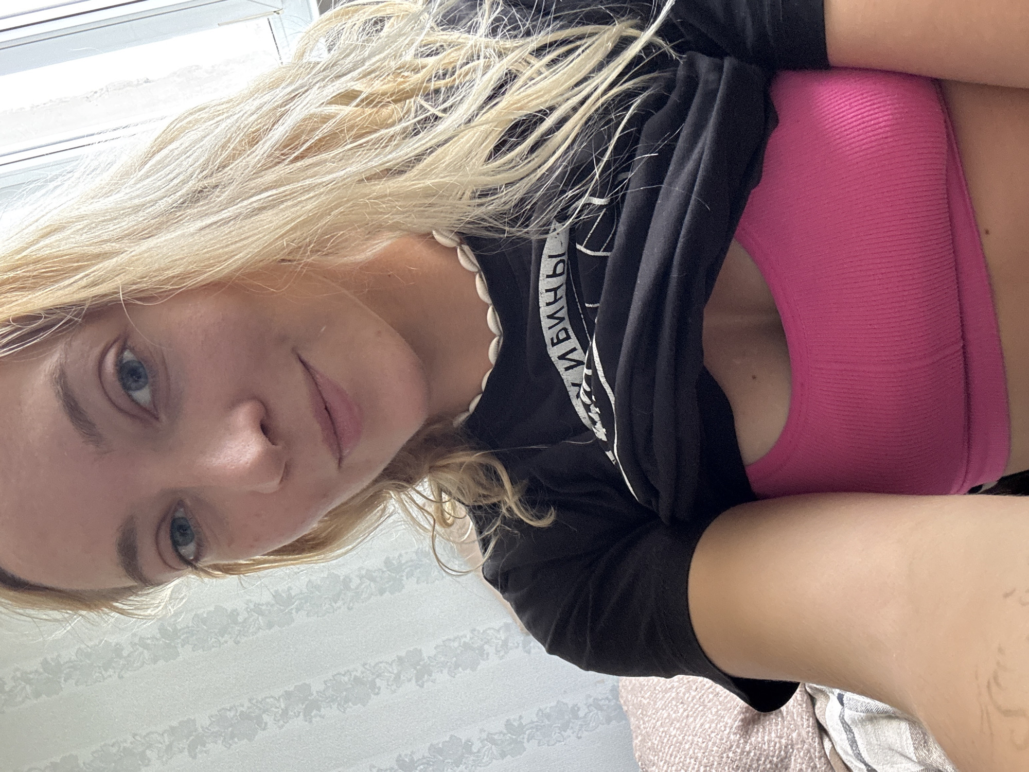 Woman photographed indoors with personal items, sleeping dog in Minsk