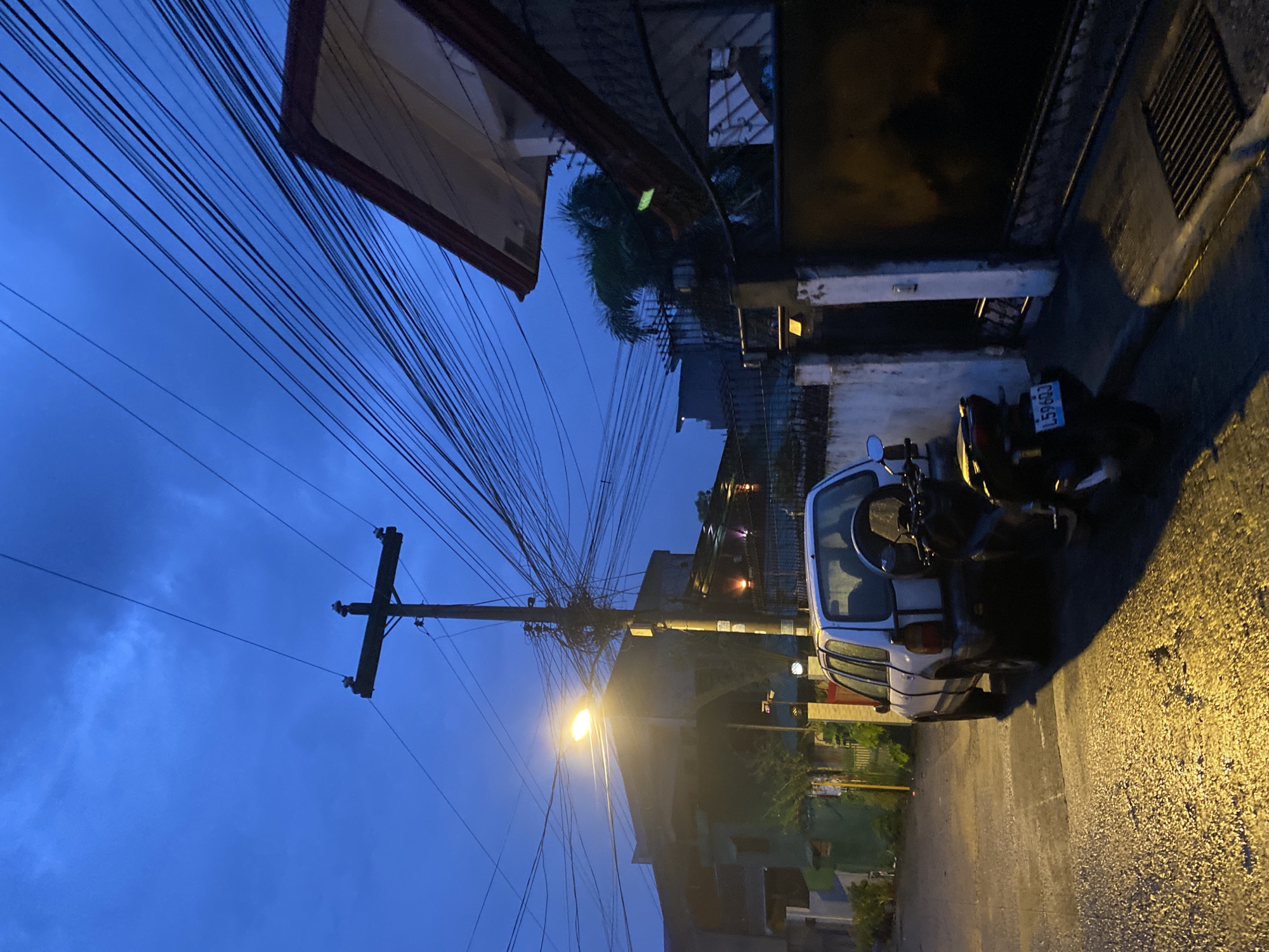 Wet streets and dusk light across a Davao City neighborhood