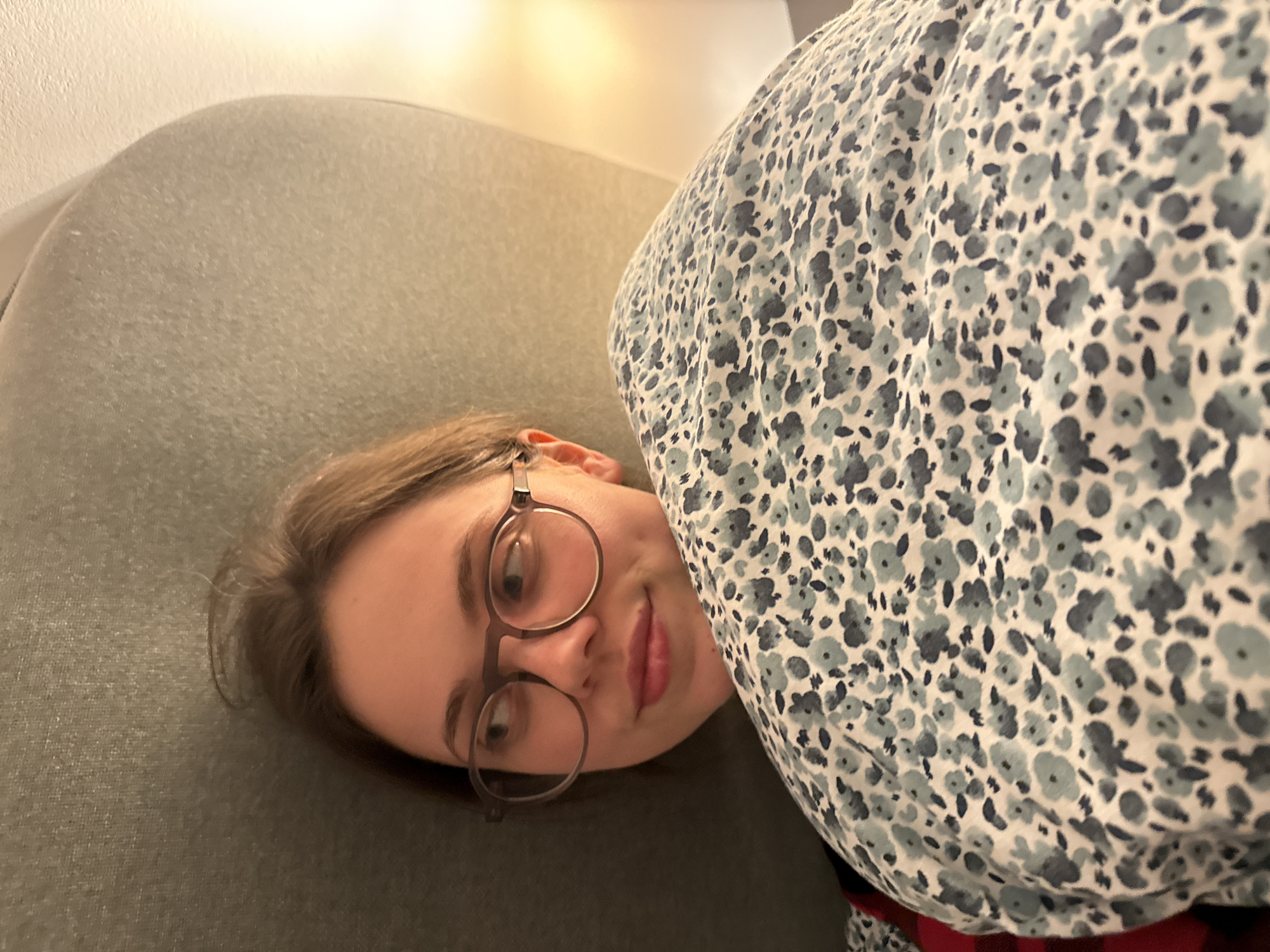 Woman rests on couch in Perugia home
