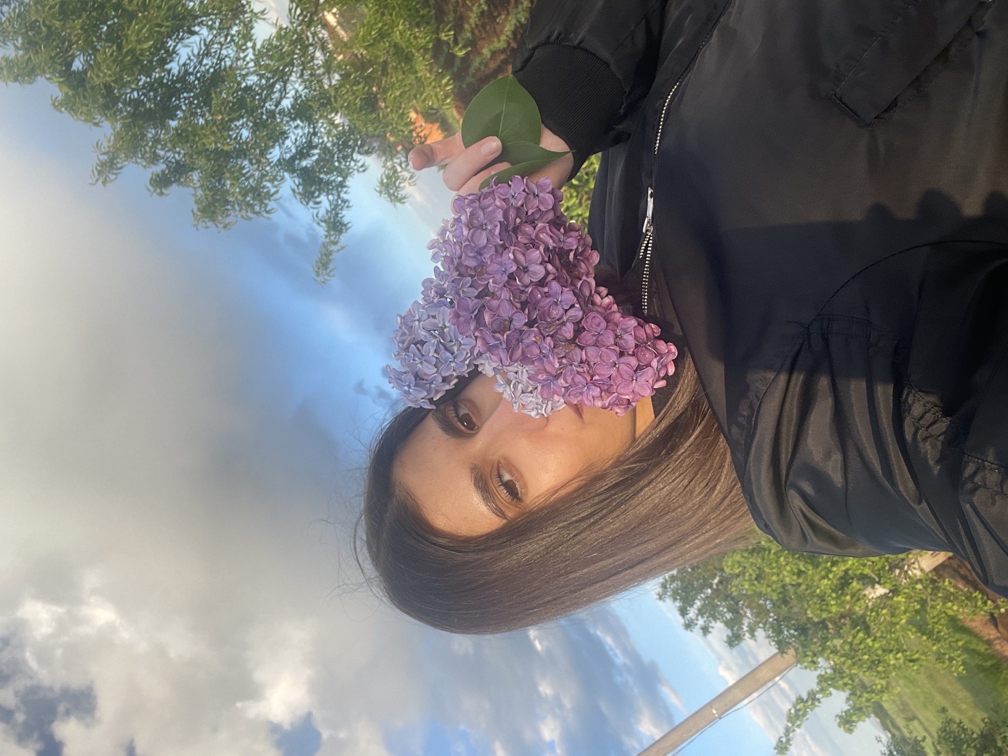 Couple photographs with lilac flowers during Sofia sunset