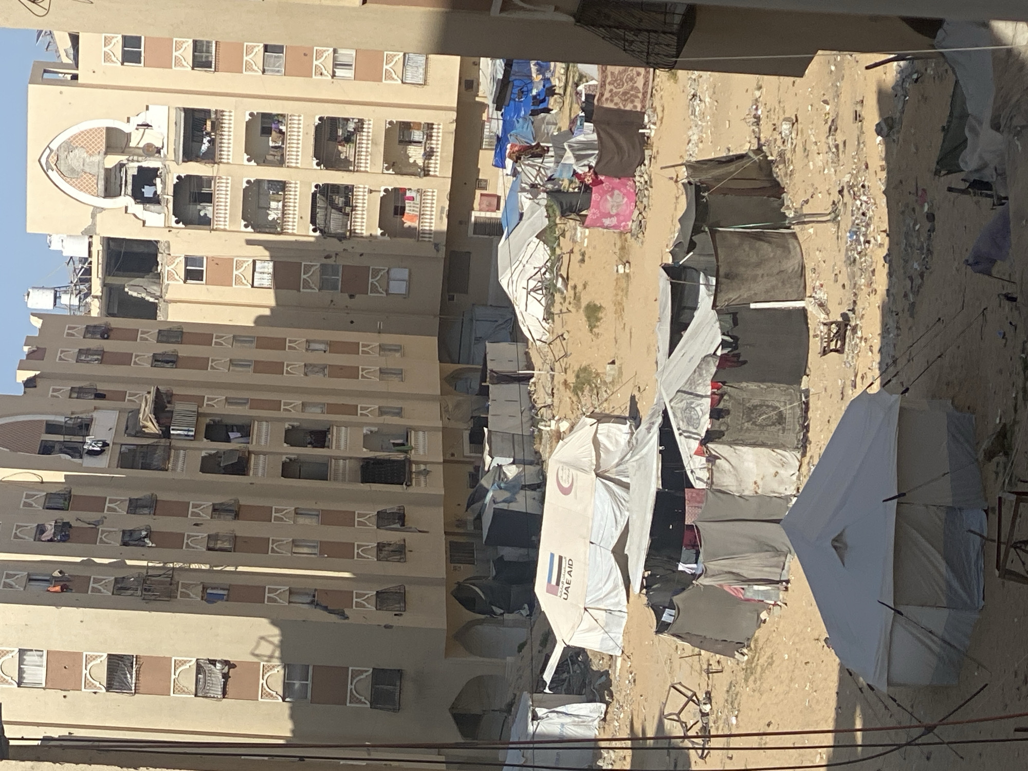 Temporary shelters documented near damaged building in Khan Yunis