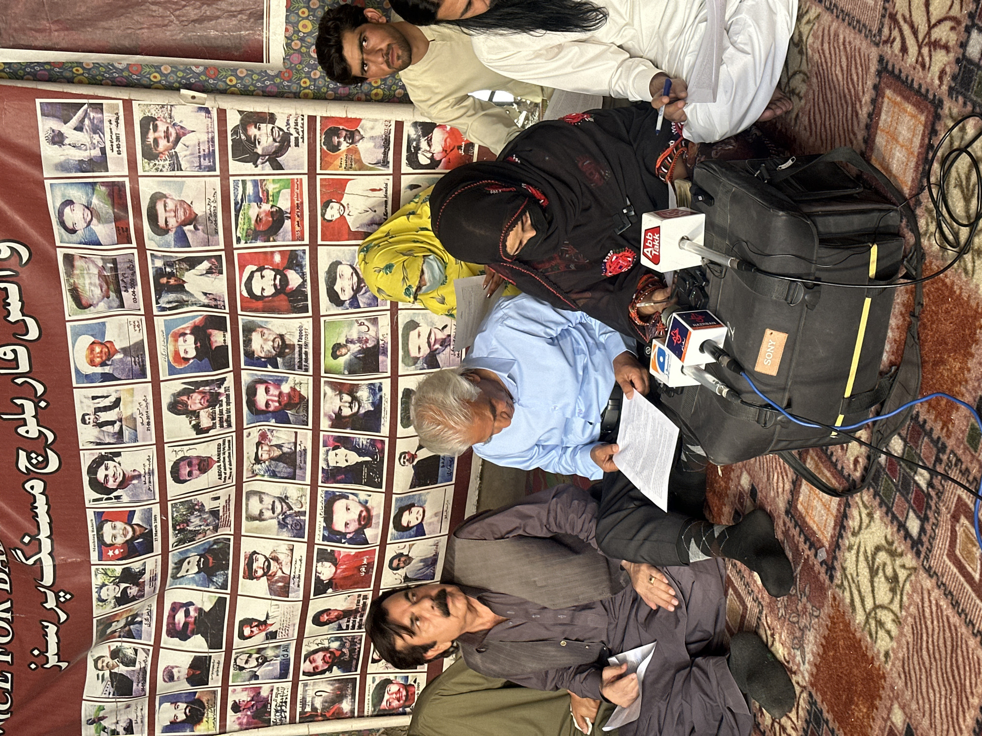 Tent gathering in Quetta features banner of photographed faces