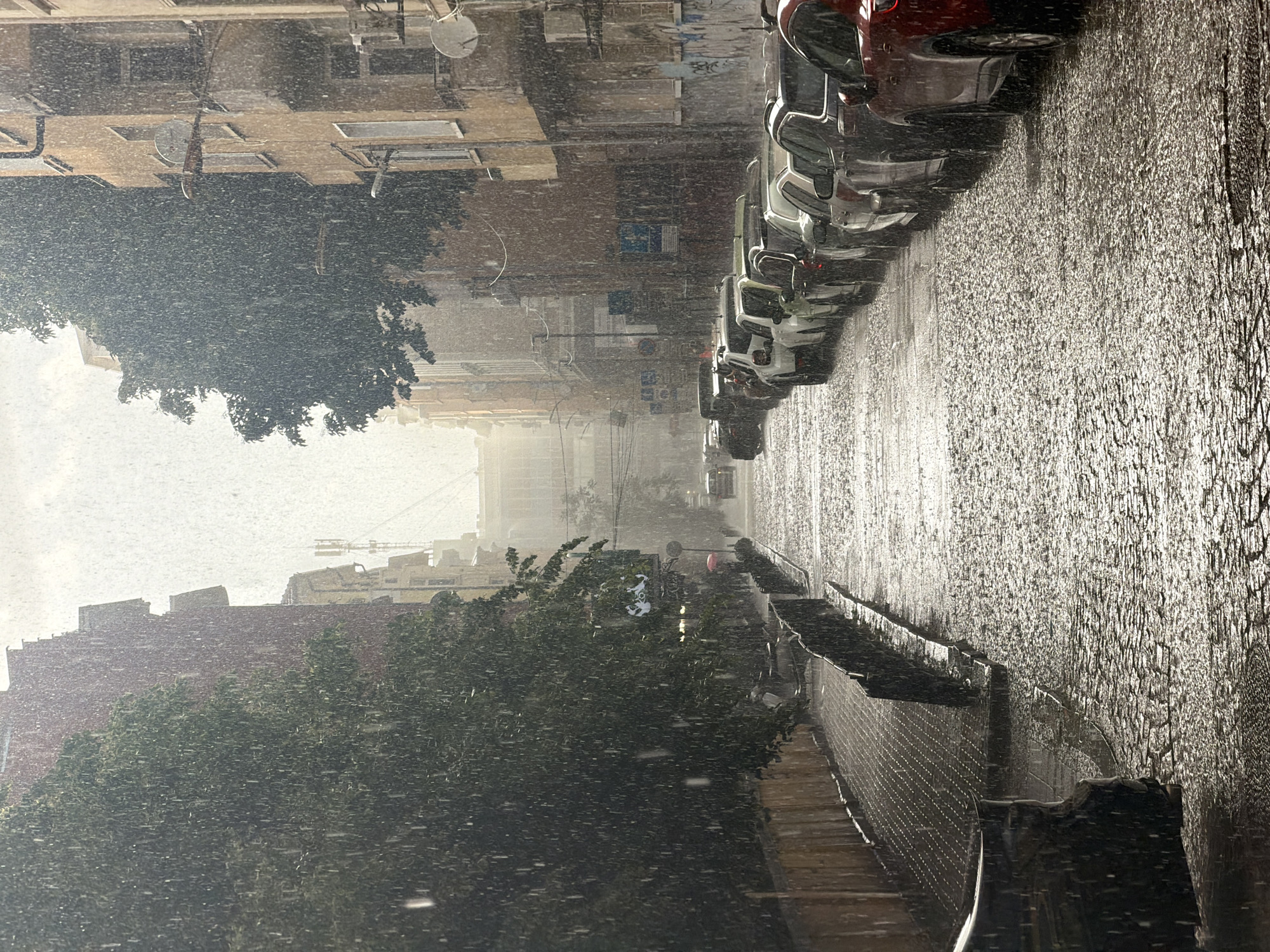 Heavy downpour drenches Sofia streets, pedestrians seek umbrella cover